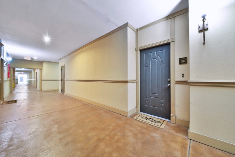 The view of hallway of unit 406--A FEW Steps away from parking garage\.