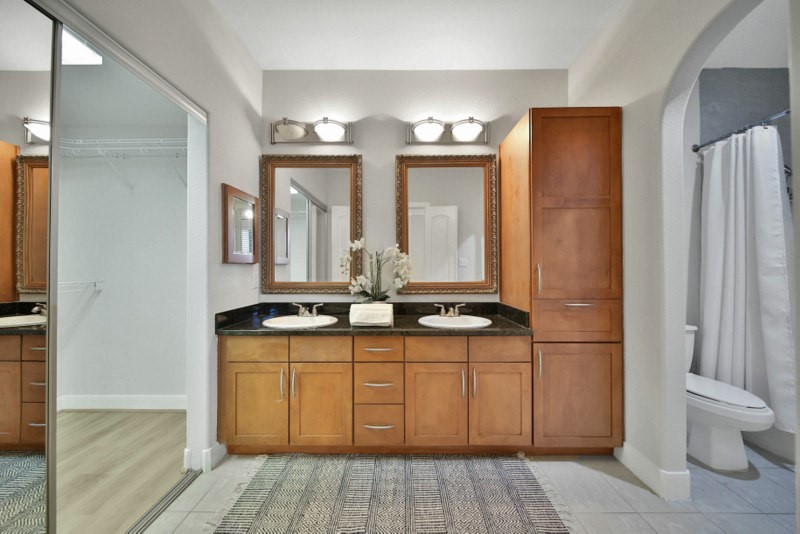 The view of En-suite primary bath W/Double sinks, granite counter-tops.