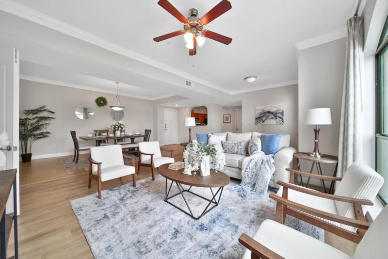The view of spacious living room W/New wood flooring, crown molding, ceiling fan. The Luxury 2/2 Condo is located in Sugar Land Town Square.