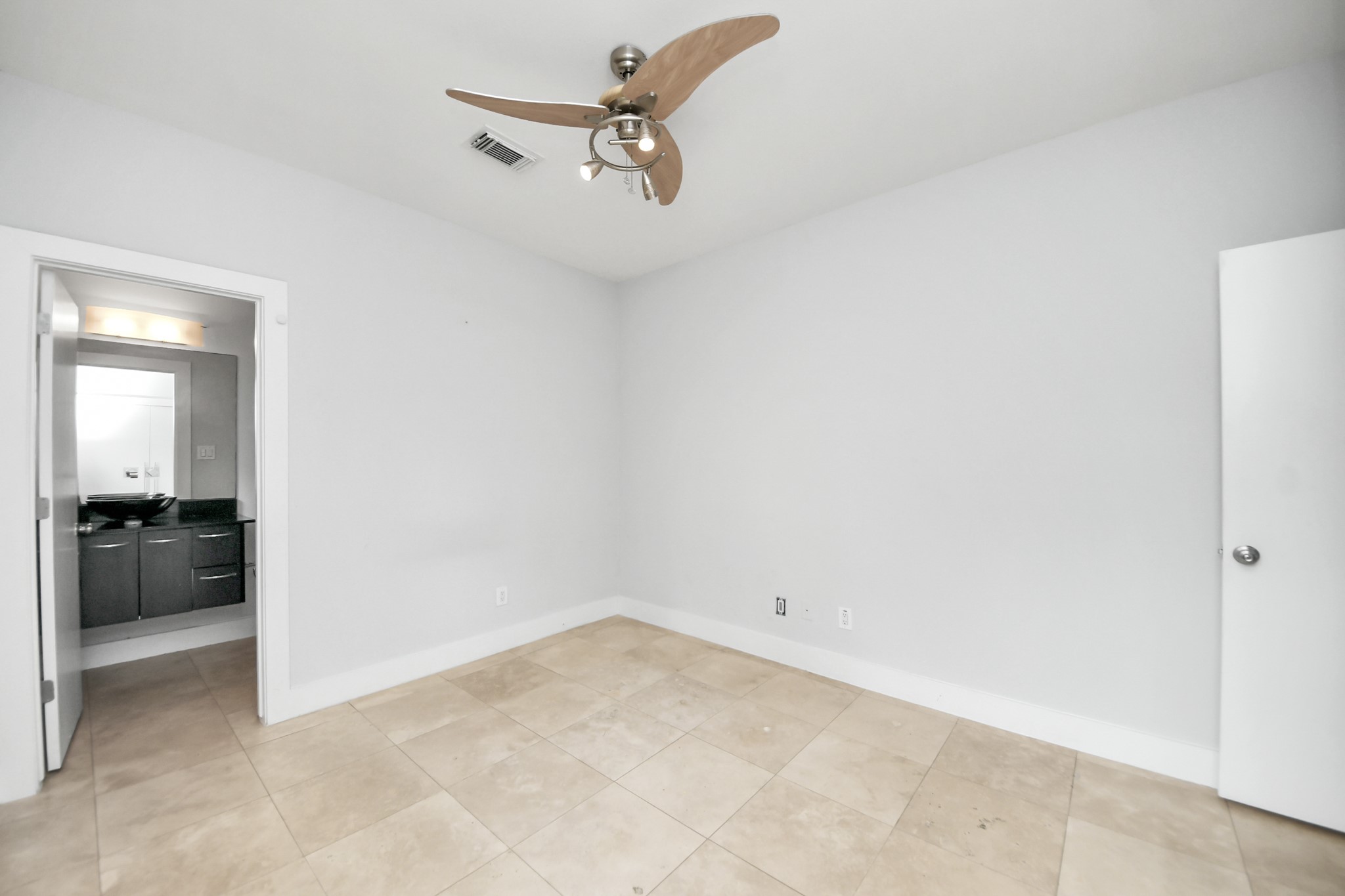 First-floor bedroom with a private full bathroom, ideal for guests.