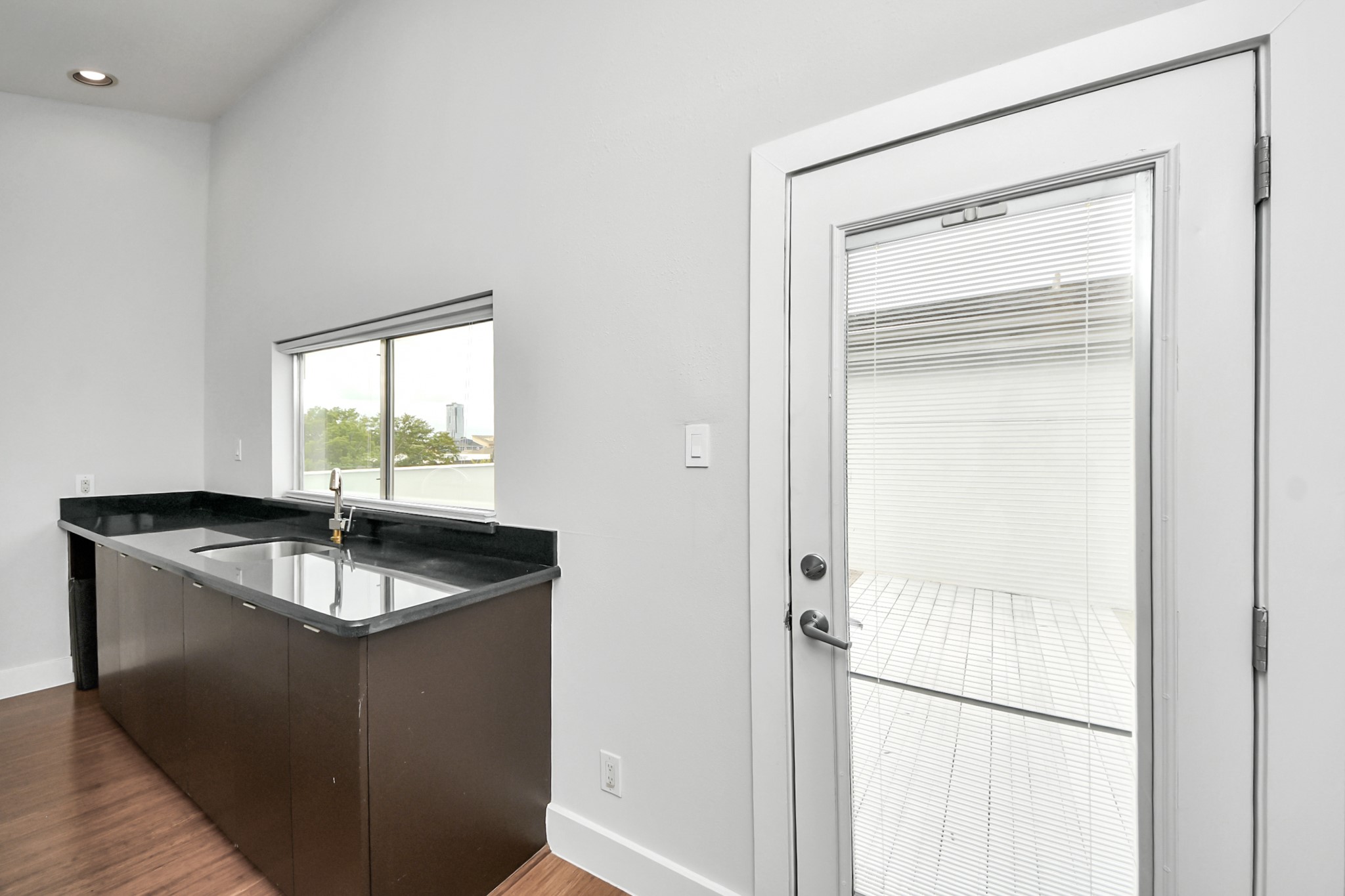 Bar area with sink leading to rooftop deck