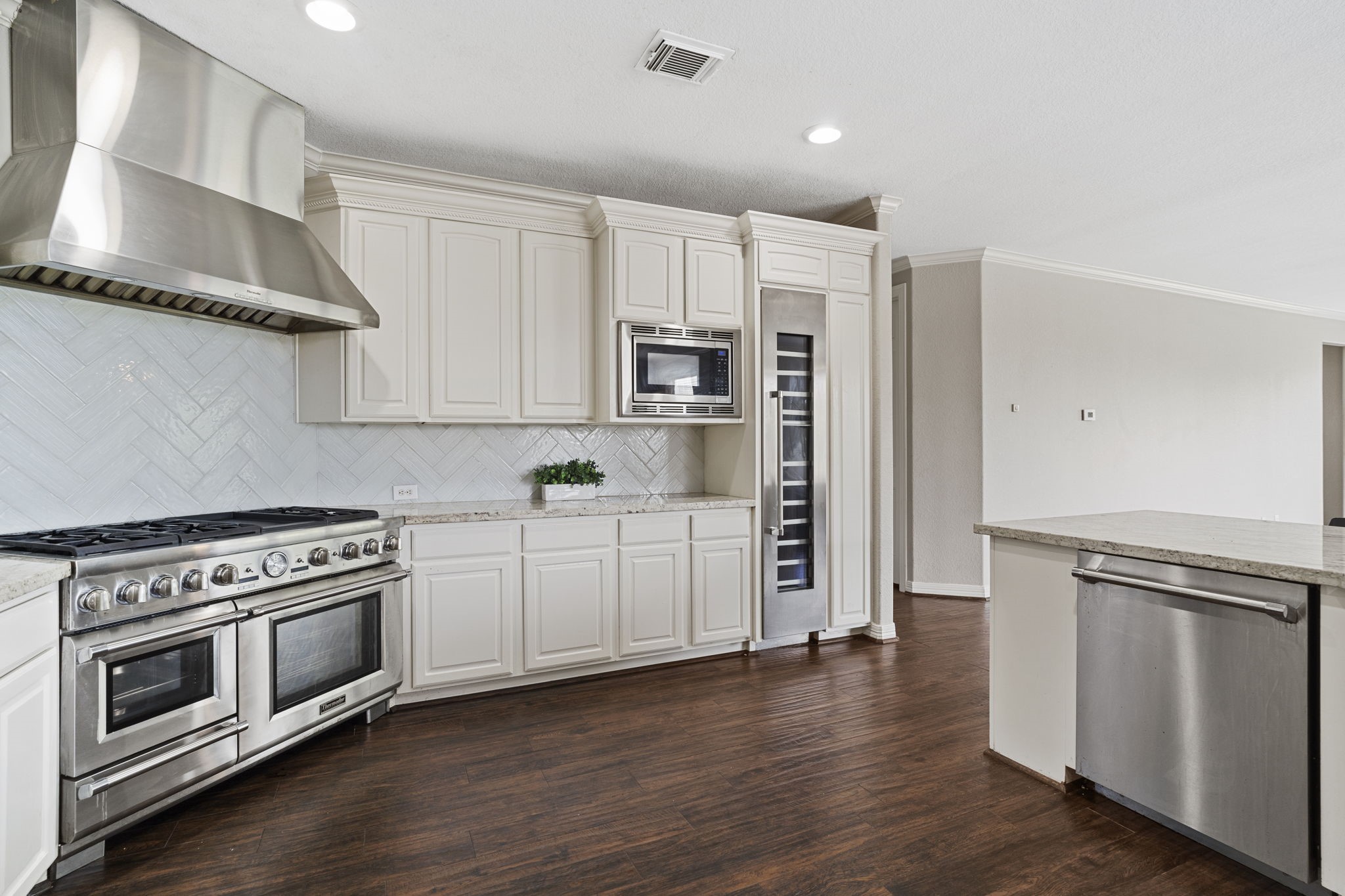 Beautifully updated kitchen featuring a timeless neutral palette and commercial-grade Thermador appliances, blending sophisticated style with exceptional functionality.