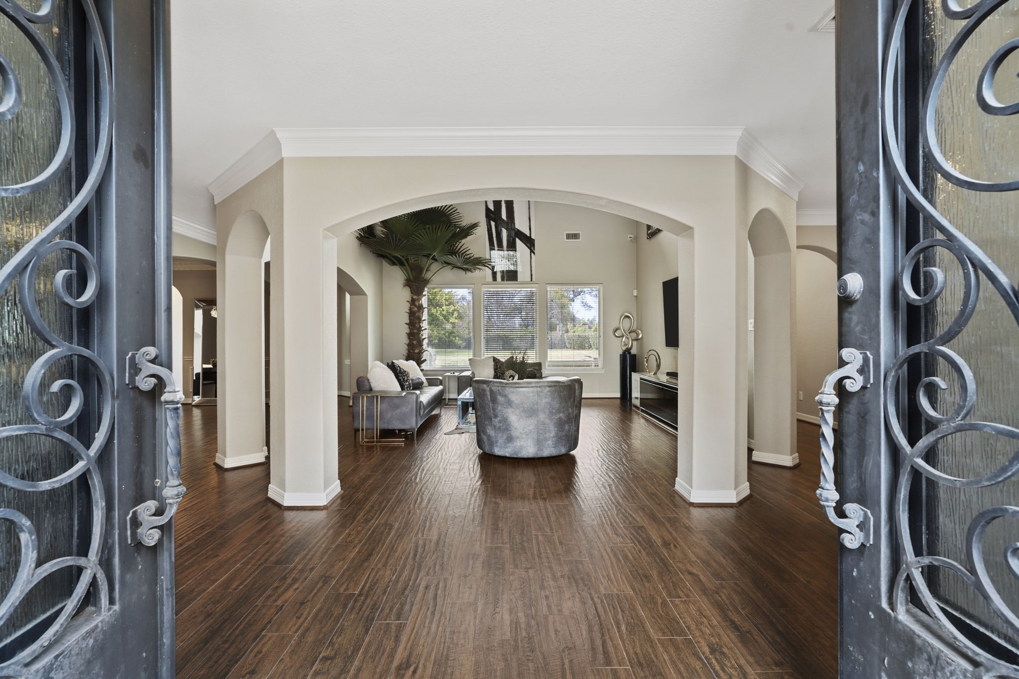 Elegant double metal entry doors create a grand and welcoming first impression.