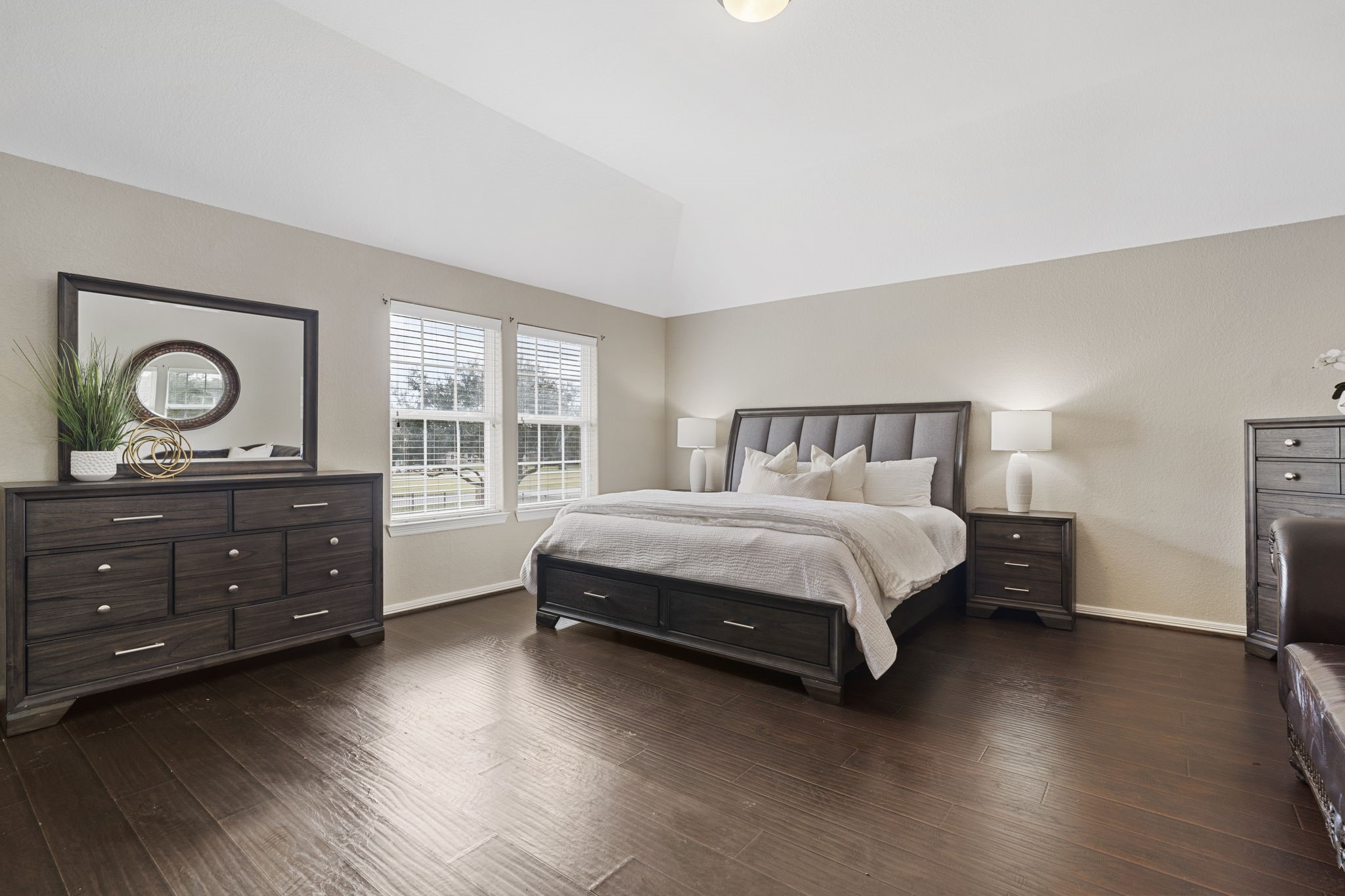 Expansive secondary bedroom featuring a walk in closet and private ensuite bathroom, offering comfort and privacy for family or guests.