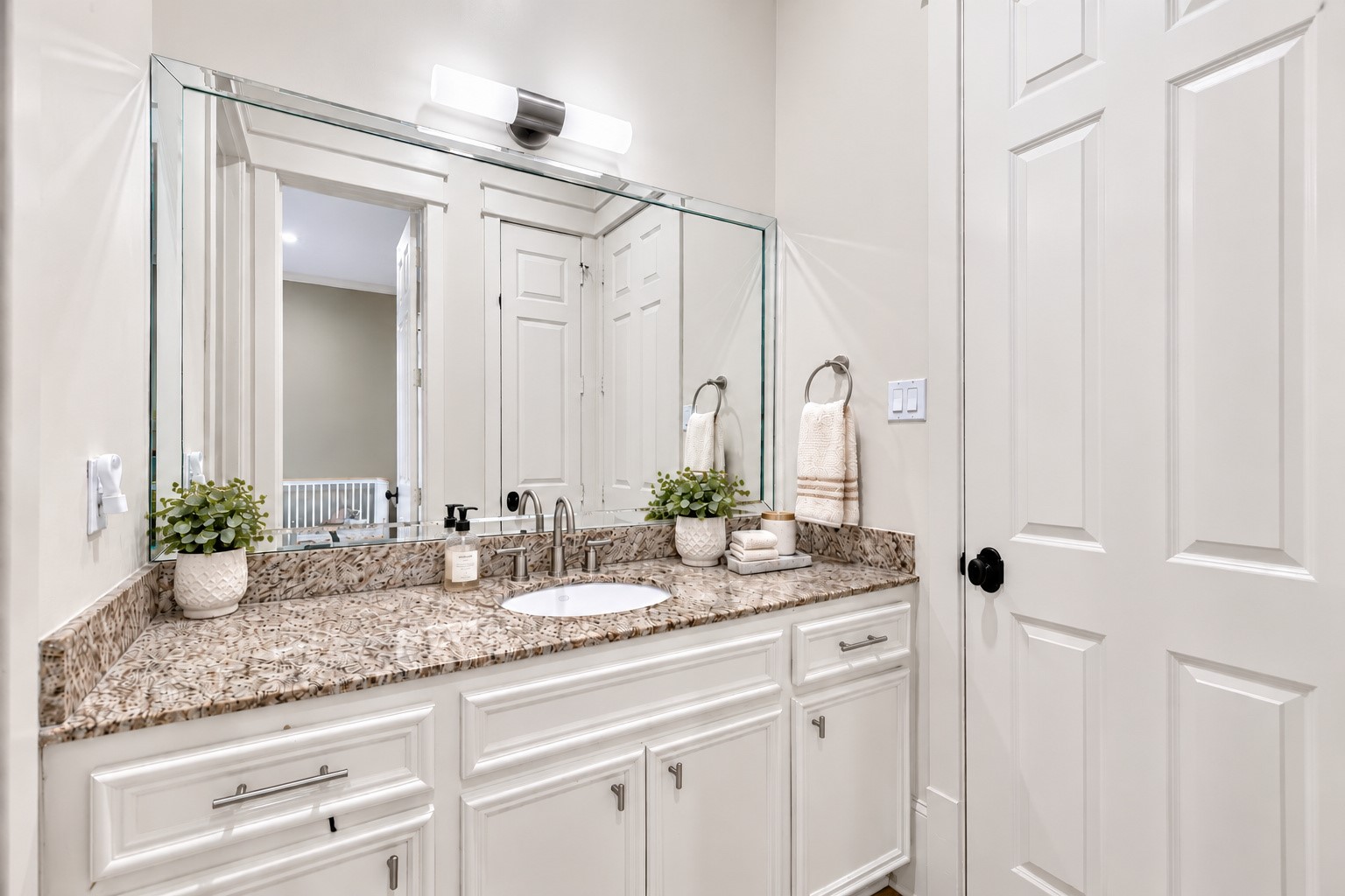 The secondary bathroom vanity and bath are accessible from both secondary bedrooms.