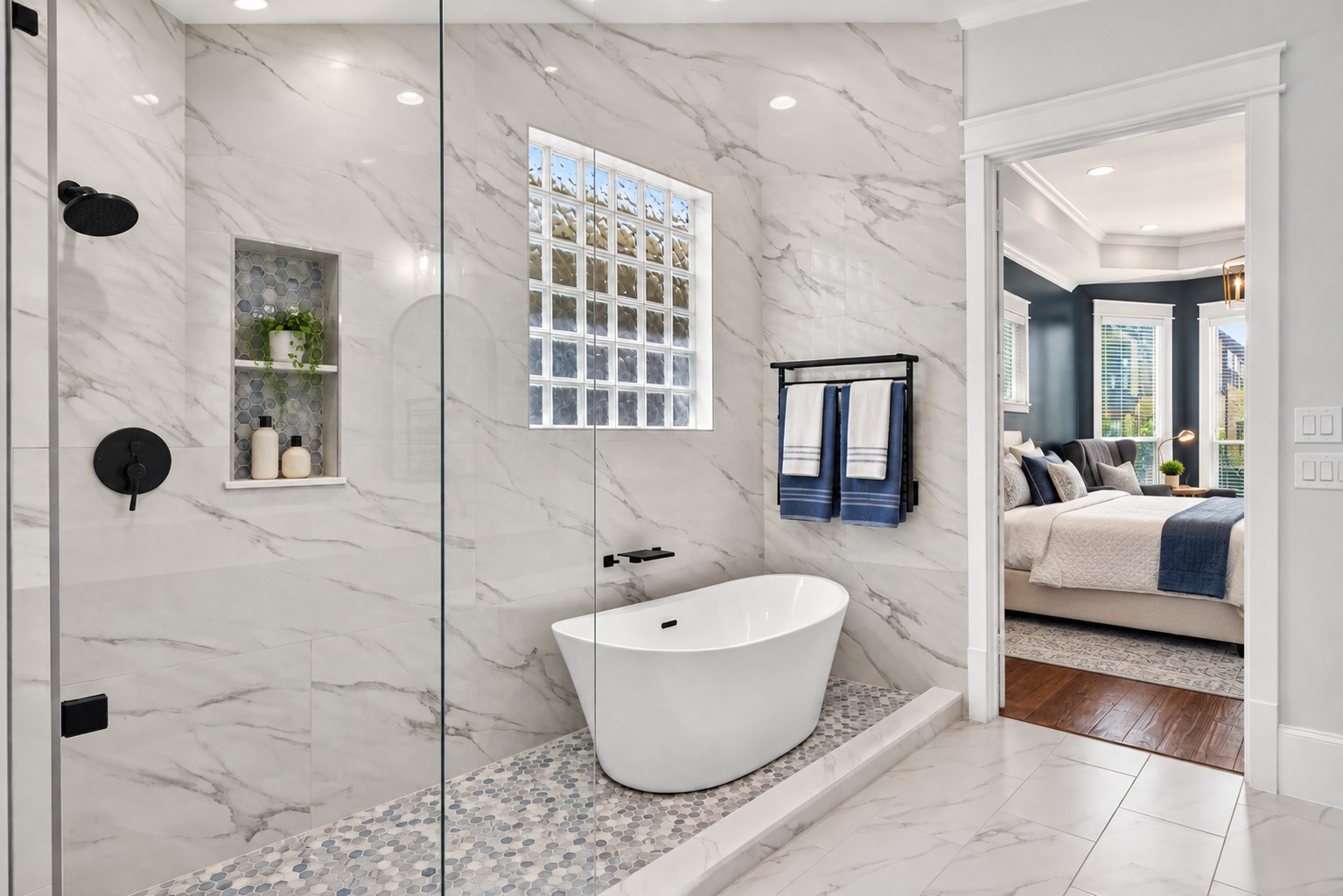 A second view showcases the impressive wet room and its seamless connection to the beautiful primary suite.