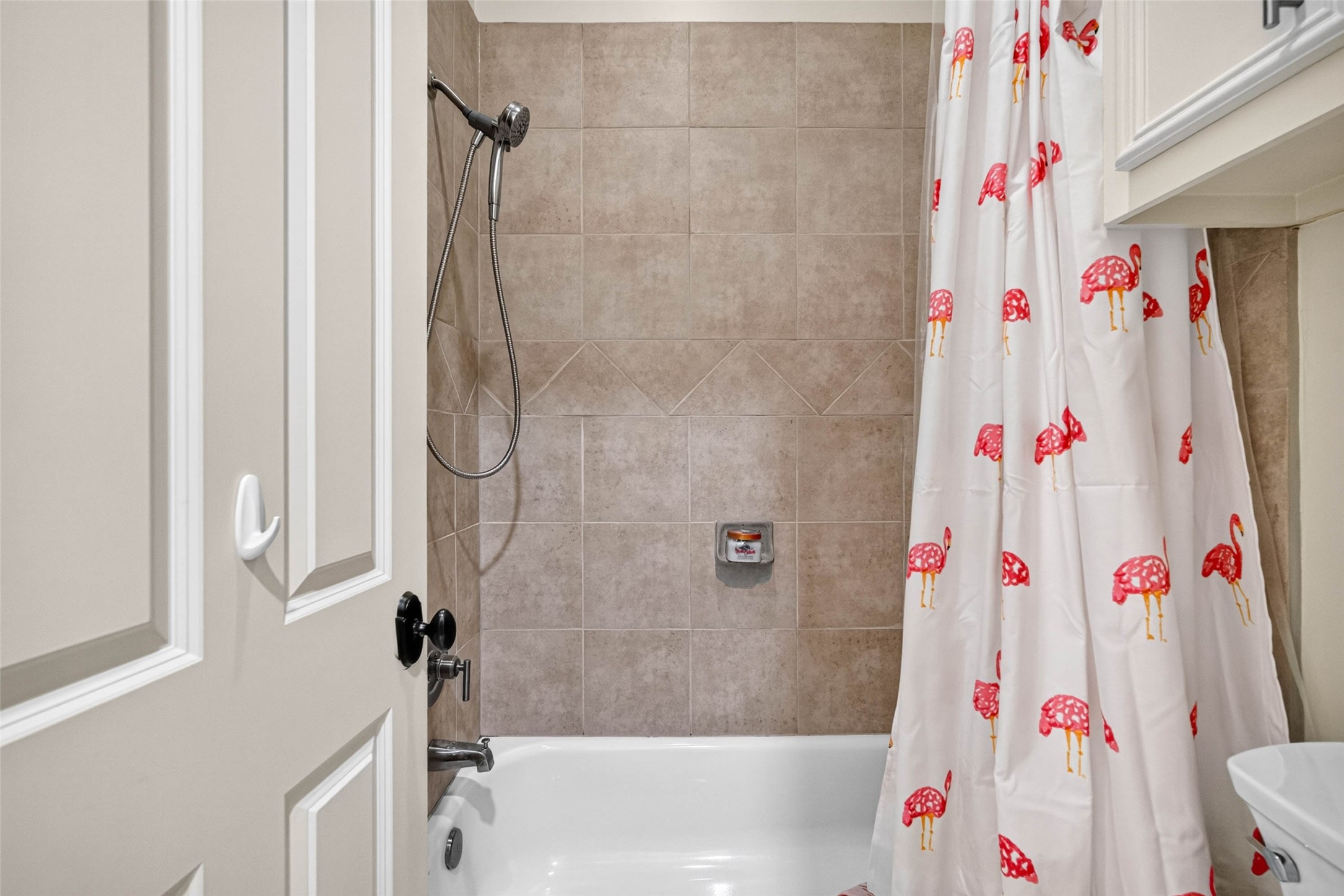 You'll find the tub/shower combination and toilet through the door to the left of the vanity