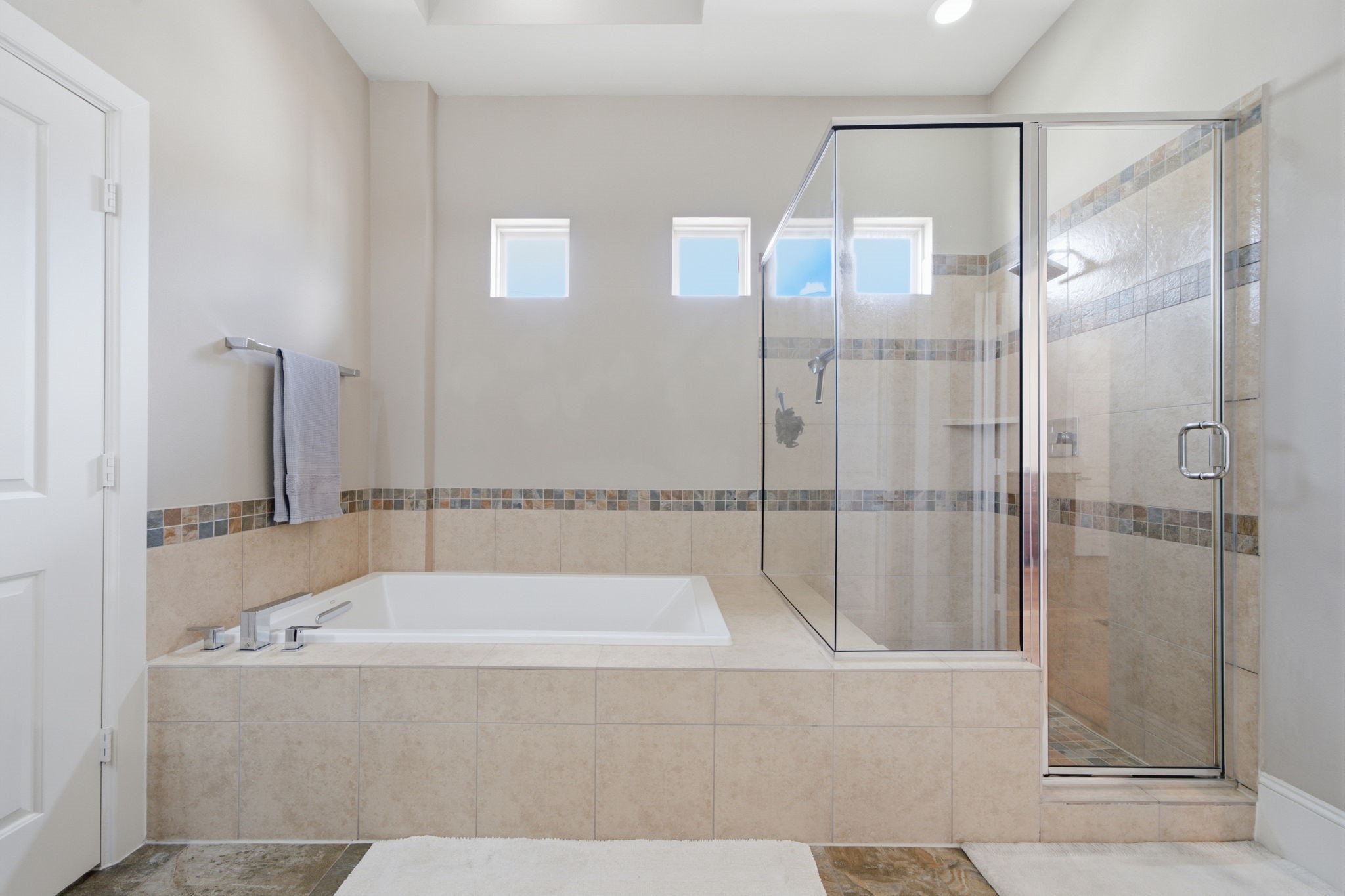 Unwind in the spacious primary bathroom, featuring a large soaking tub that's perfect for relaxing after a long day.