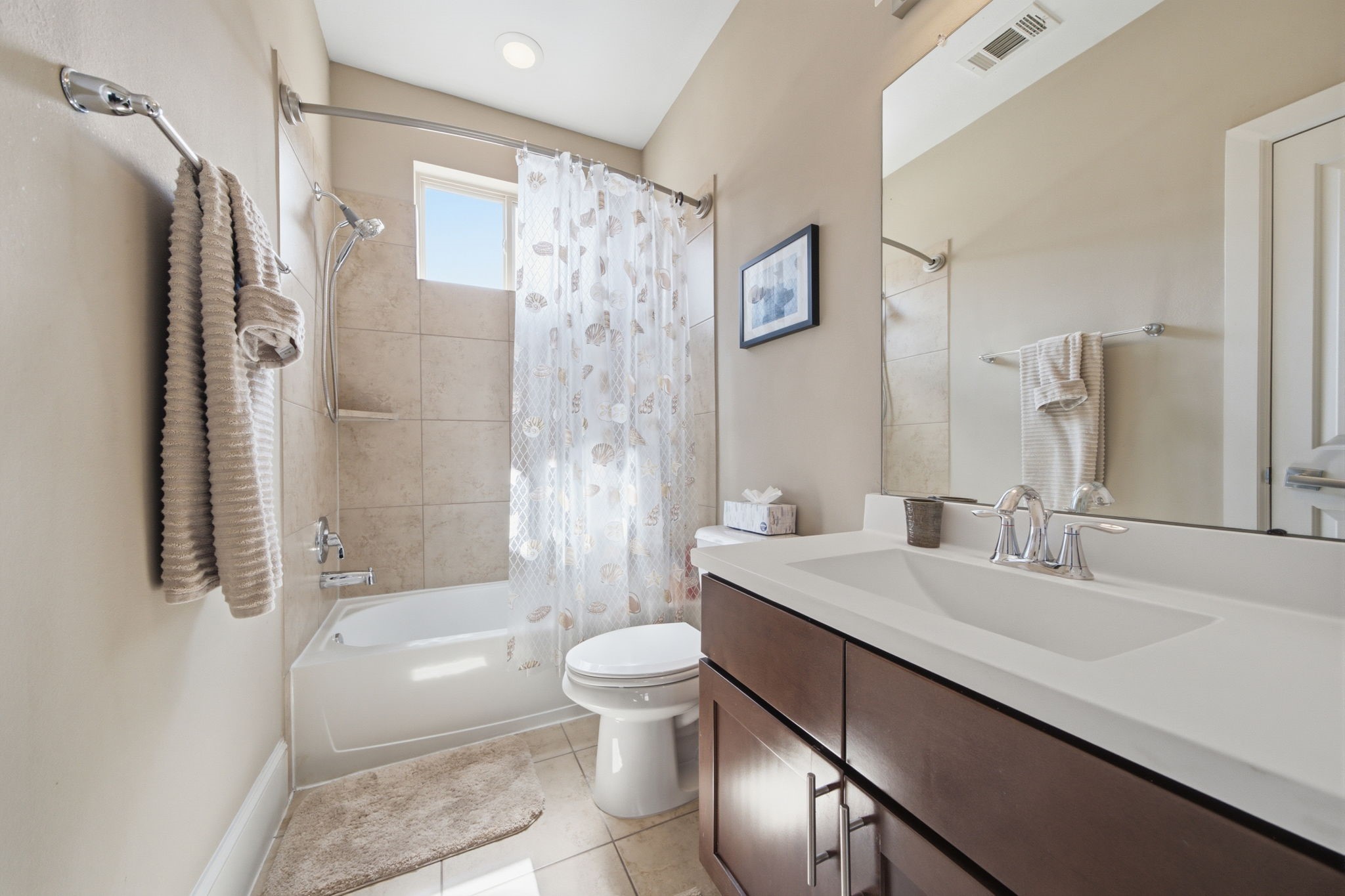 An additional full bath upstairs provides comfort for family and visitors alike.