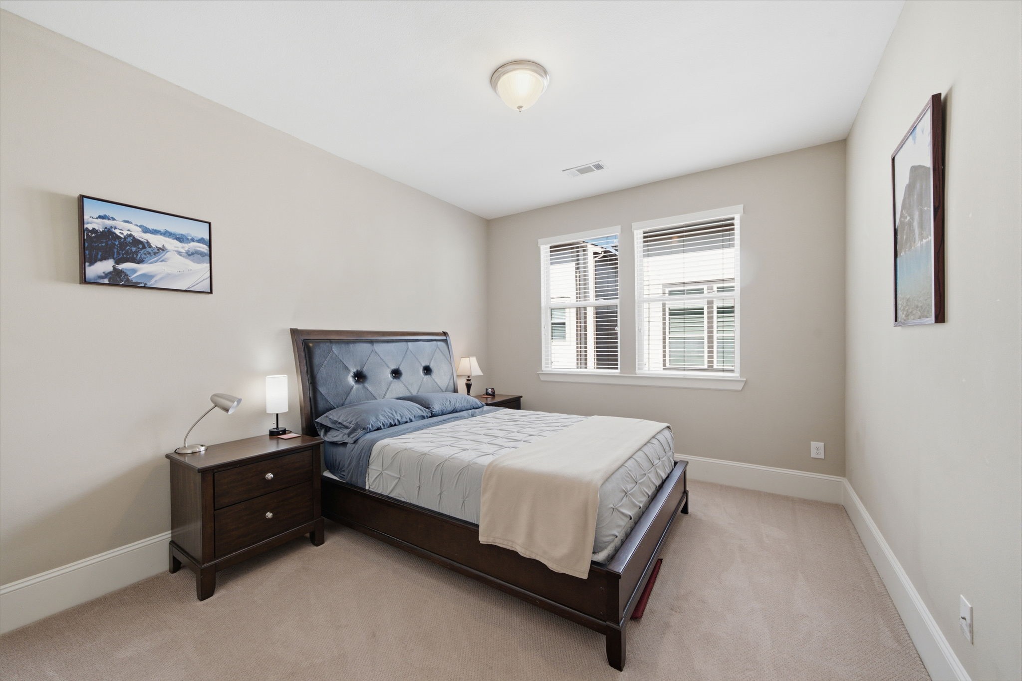 The upstairs secondary bedroom is generously sized and filled with natural light.