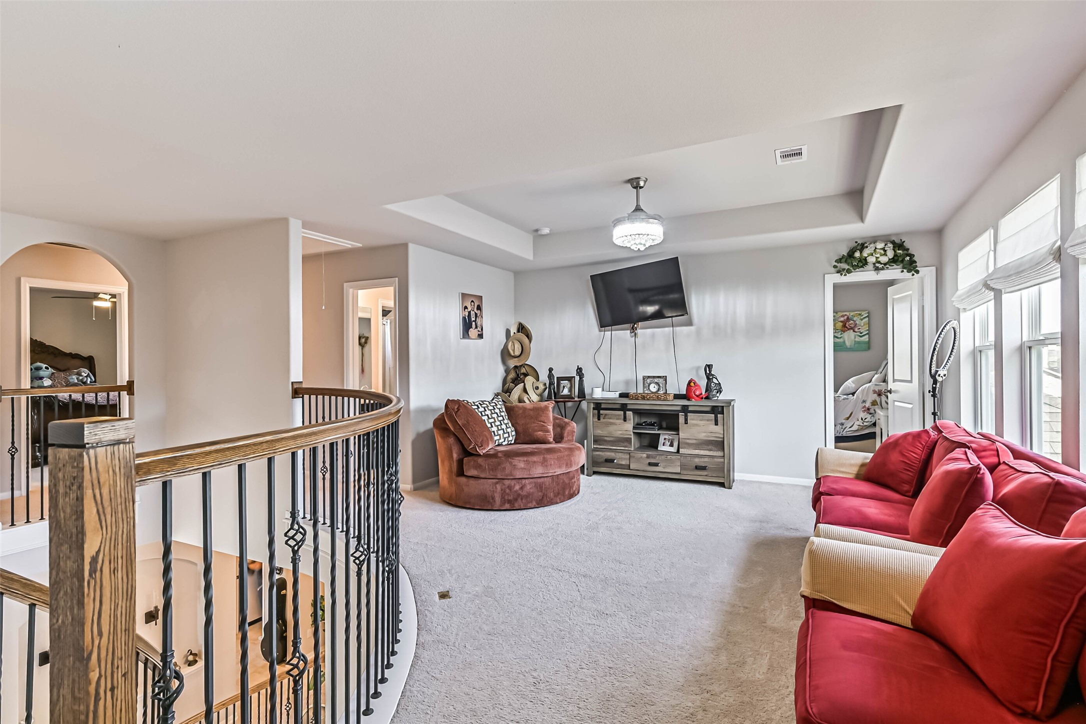Another view of the upstairs living area, offering plenty of room for entertaining, relaxing, or movie nights.