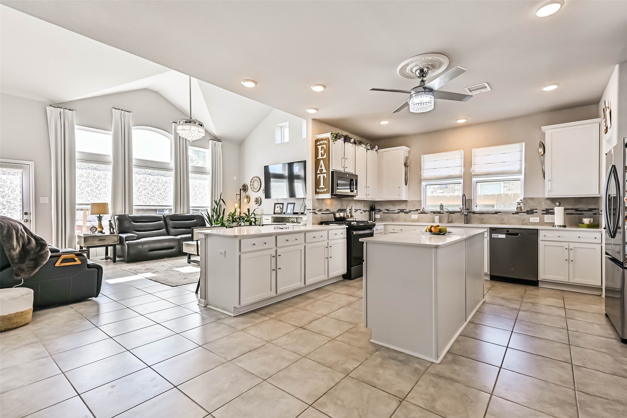 Spacious kitchen featuring two islands, ample cabinetry, recessed lighting, and an open layout perfect for everyday living and entertaining.