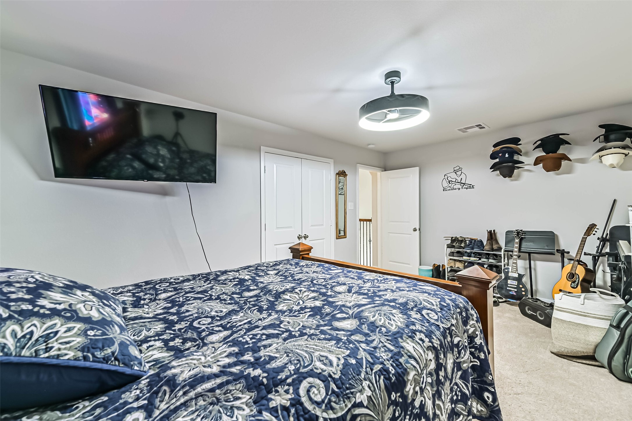 Spacious bedroom offering a comfortable layout with ceiling fan and room for additional furniture or a workspace.