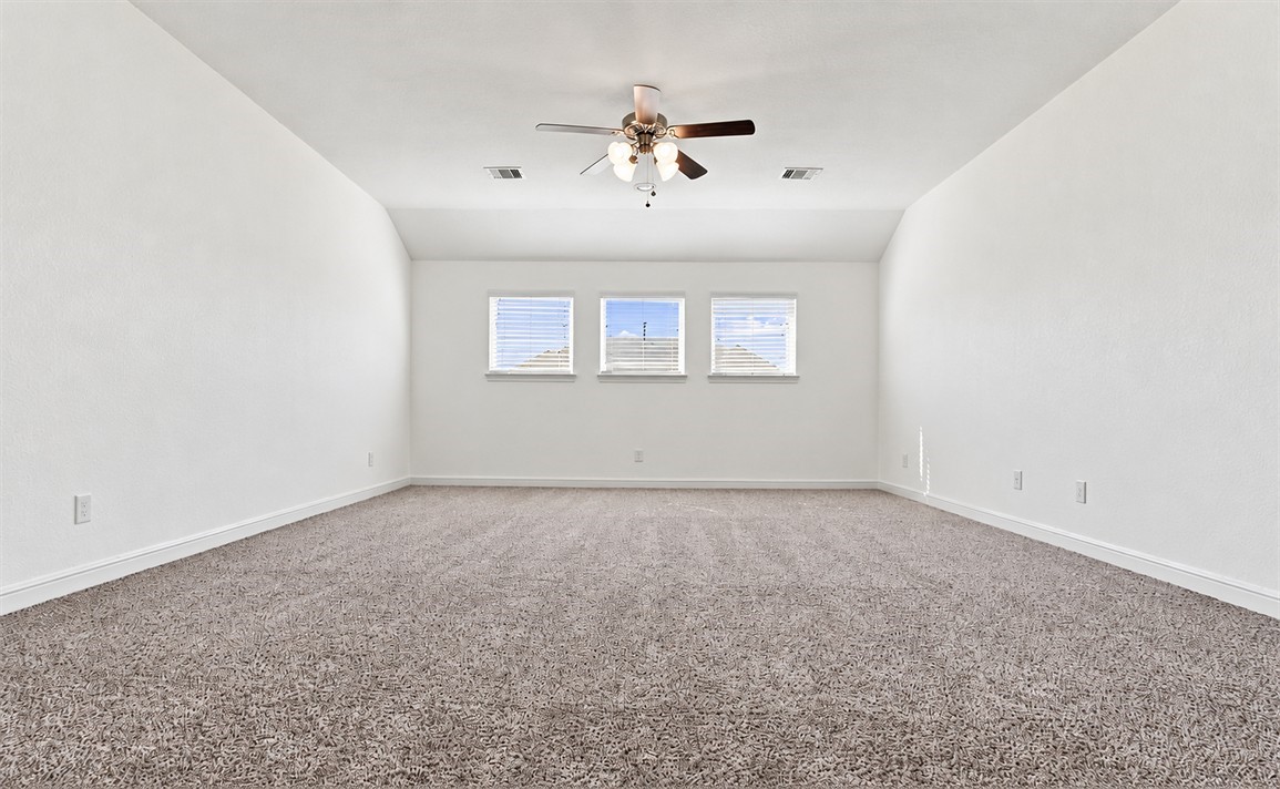 Upstairs you'll find this flexible over-sized game room with carpet flooring, ready to become whatever your family needs, a play area, hangout spot, or second living room.