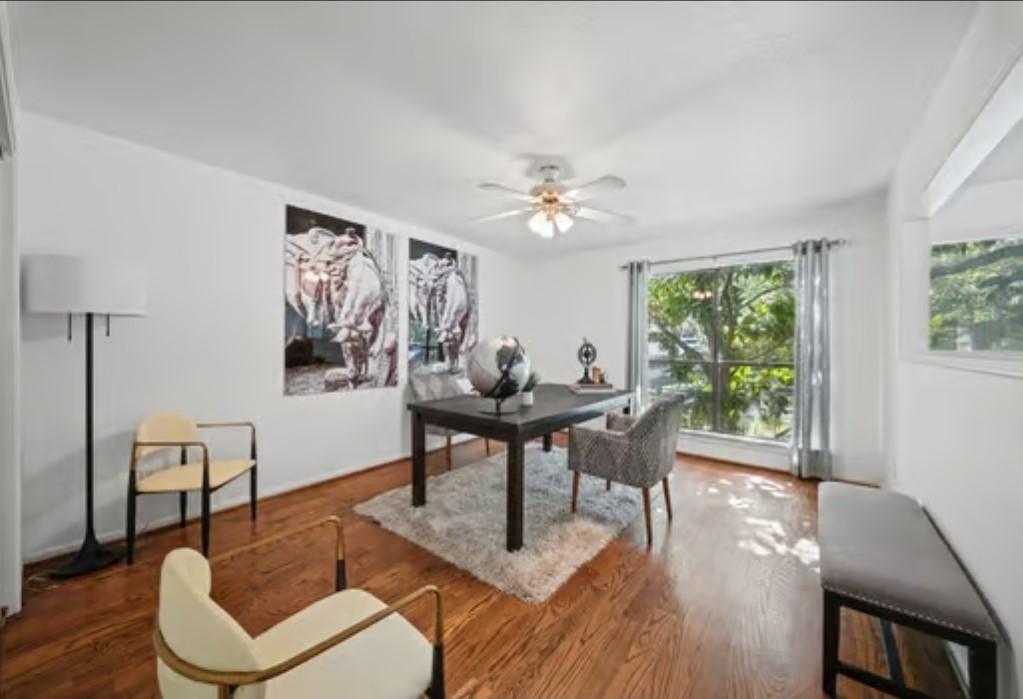 The 2nd bedroom offers hardwood floors, large windows for natural light. Here it's being used as an inviting home office with modern decor, offering a quiet atmosphere for a more productive working environment
