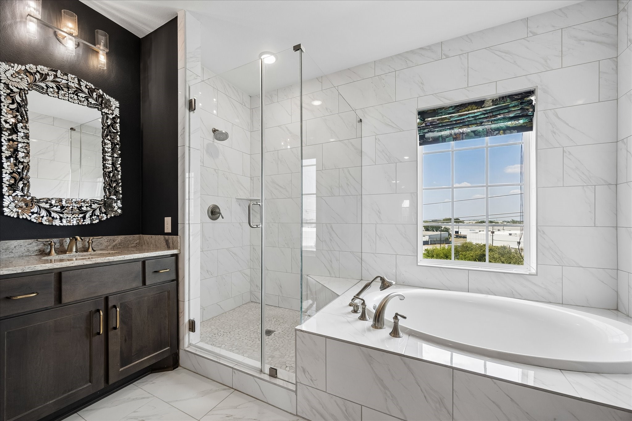 The elegant bath creates a tranquil escape with a soaking tub, oversized shower, and abundant storage.