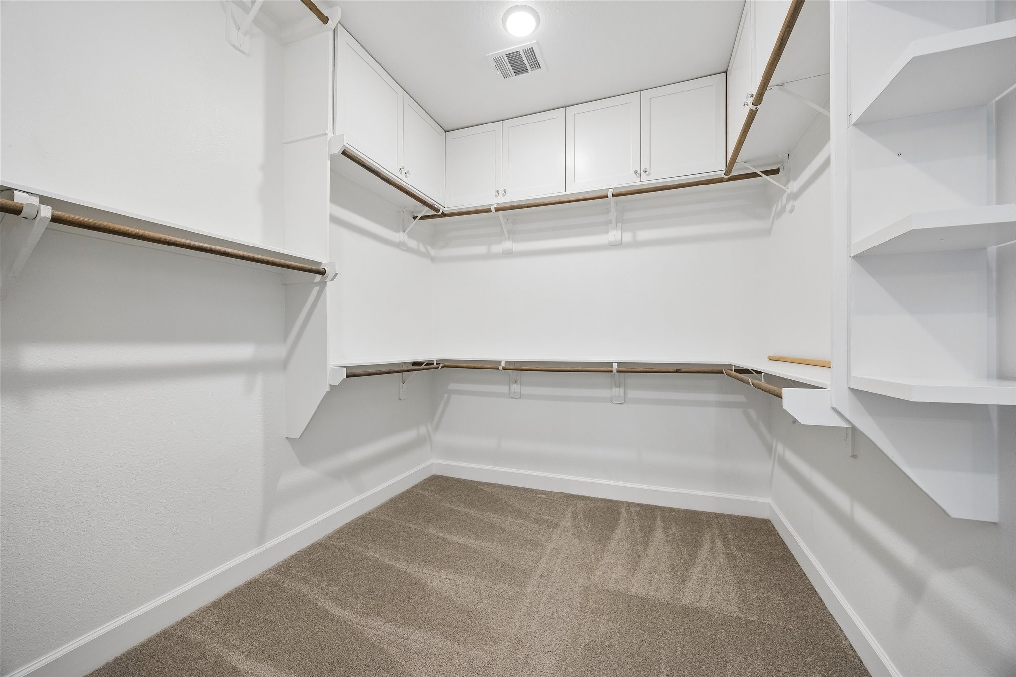 The spacious walk-in closet offers exceptional storage and organization for even the most extensive wardrobe.