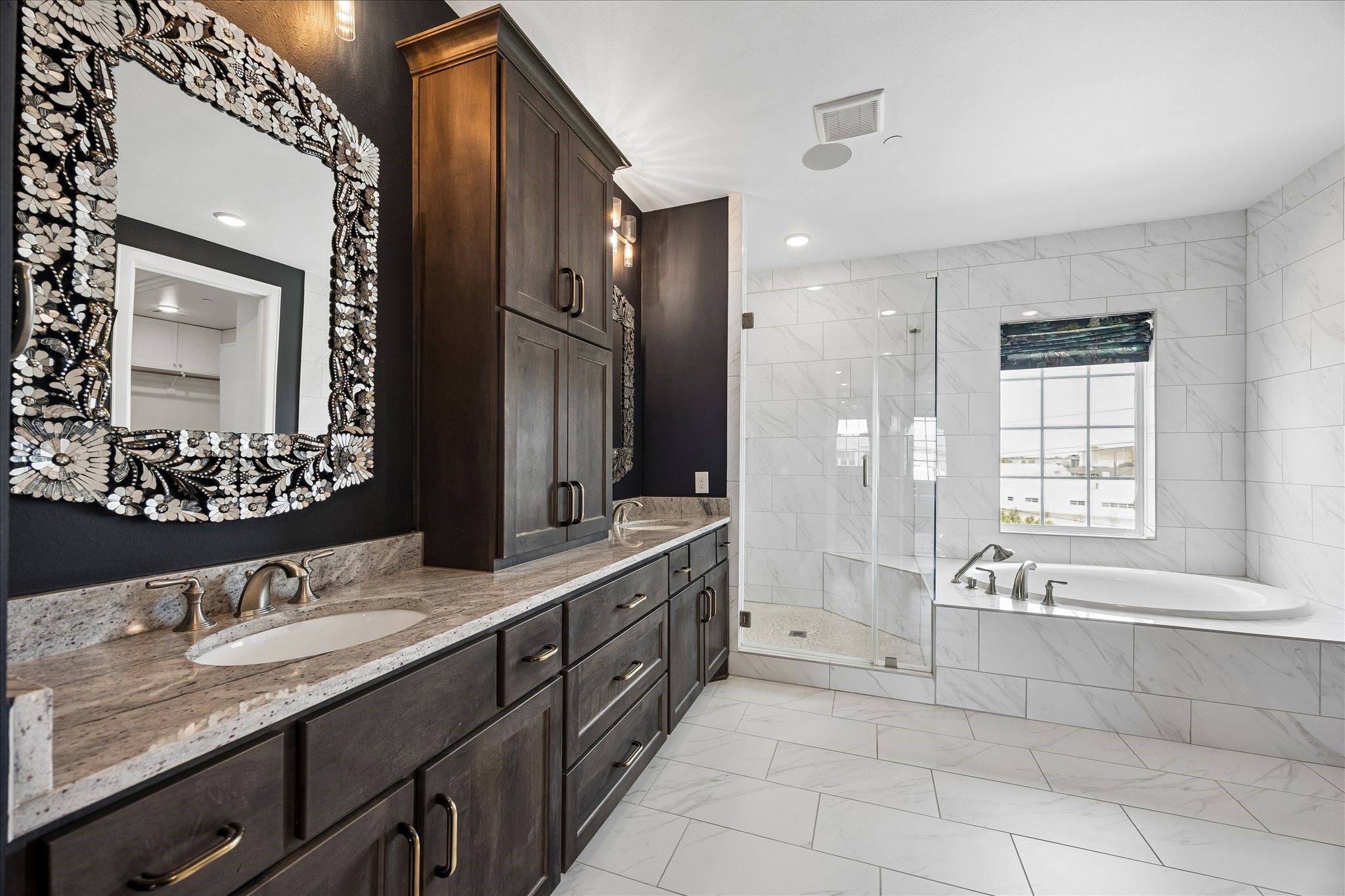 Inspired by luxury spas, the primary bath features sophisticated finishes, dual vanities, and exceptional attention to detail.