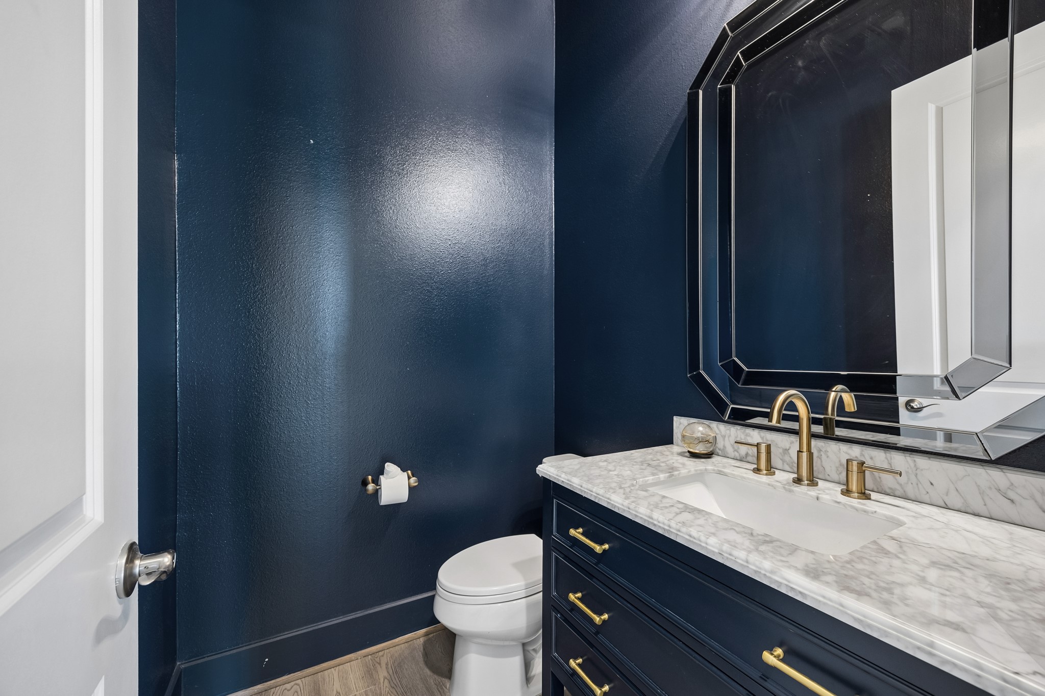 Thoughtfully designed for guests, the powder bath showcases sophisticated finishes, designer lighting, and refined details that elevate even the smallest spaces with style and elegance.