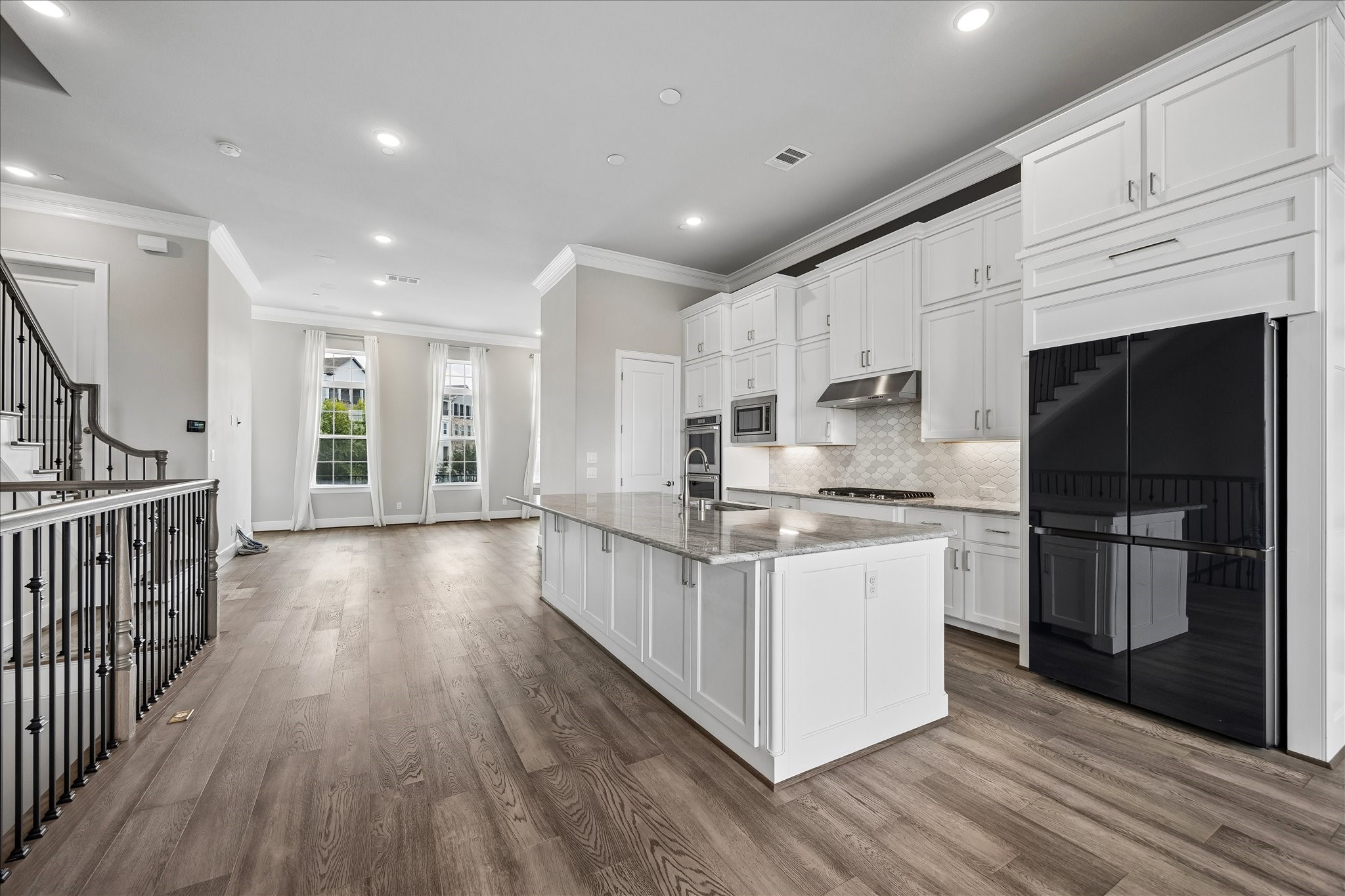 The chef-inspired kitchen combines beauty and functionality with premium appliances, ample storage, and designer finishes.