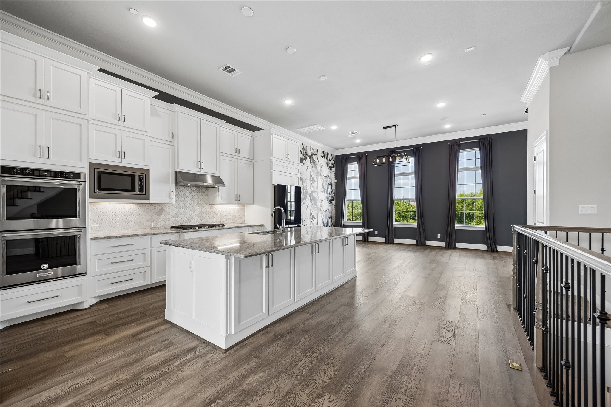 A spacious island anchors the kitchen, providing the ideal space for cooking, casual dining, and entertaining guests.