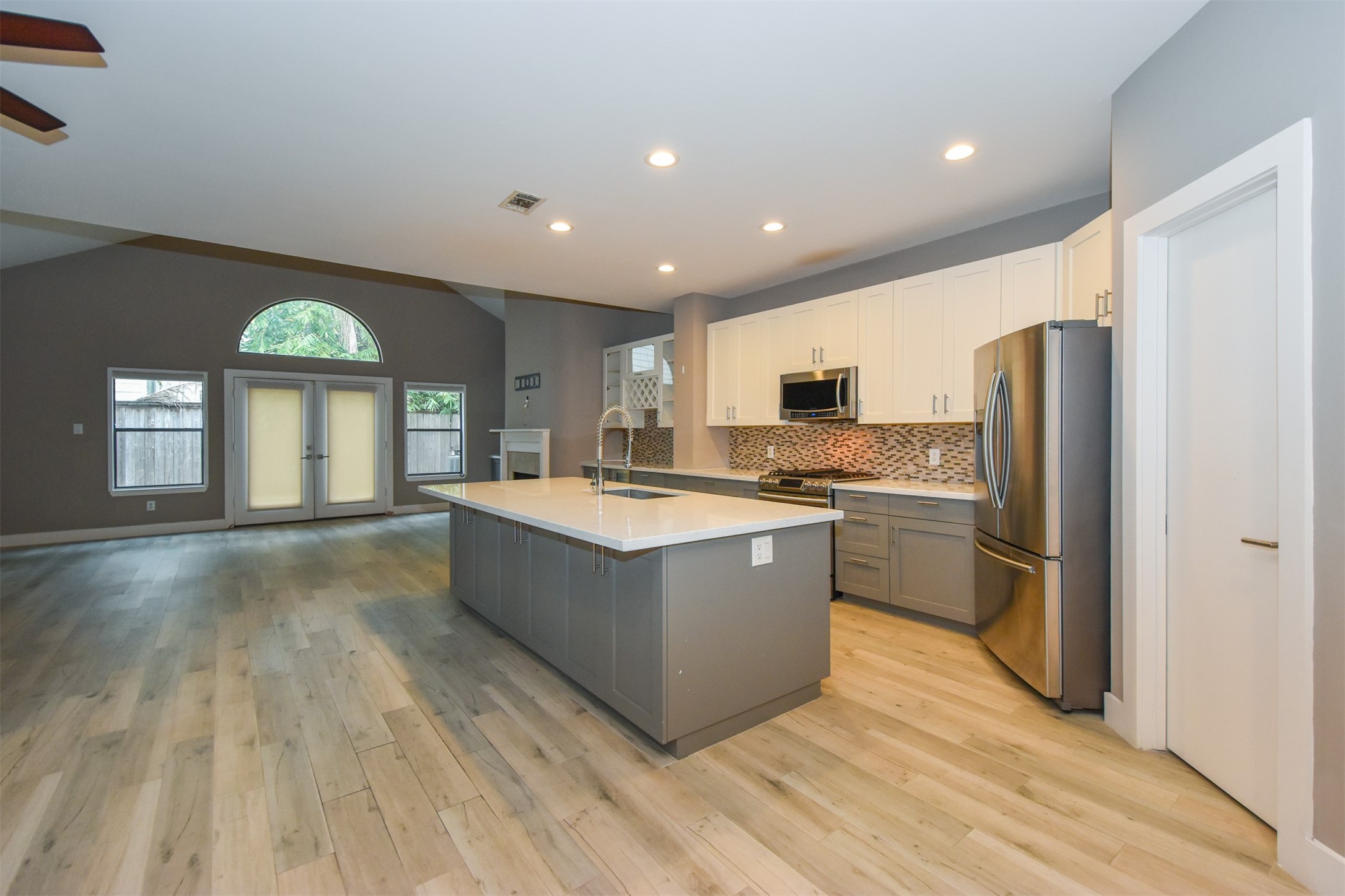 Open Kitchen concept with island. Recently updated with quartz counters, glass tile backsplash, stainless steel appliances & recessed lights.