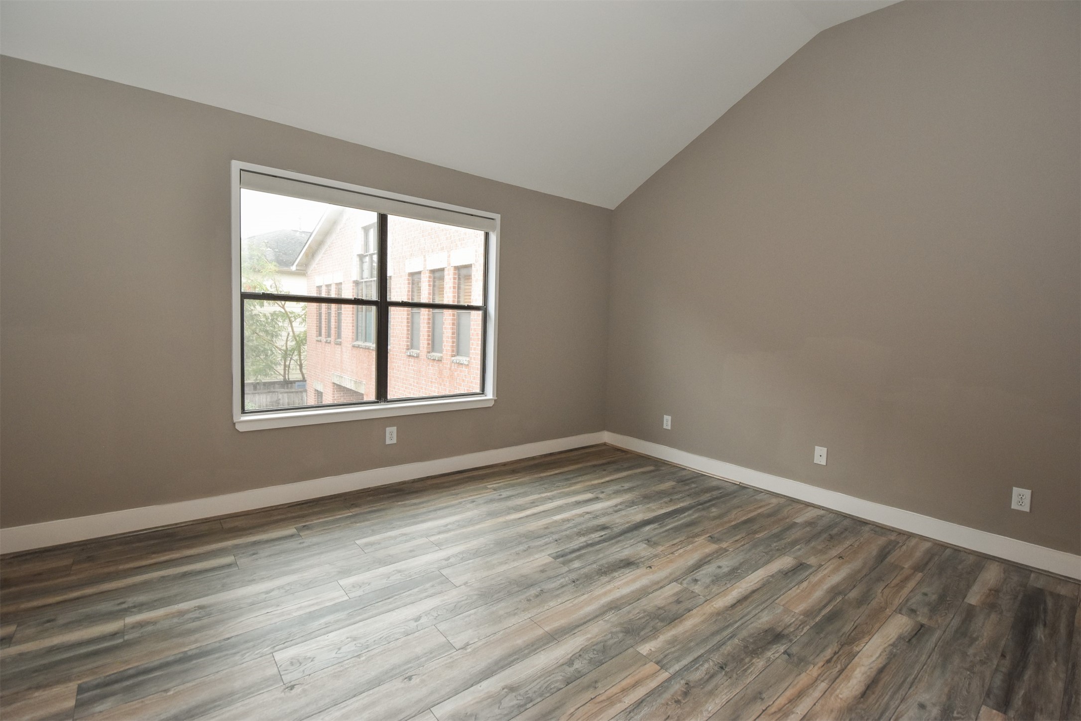 Spacious Primary Bedroom. Note the updated laminated floor & fresh paint throughout the second floor.