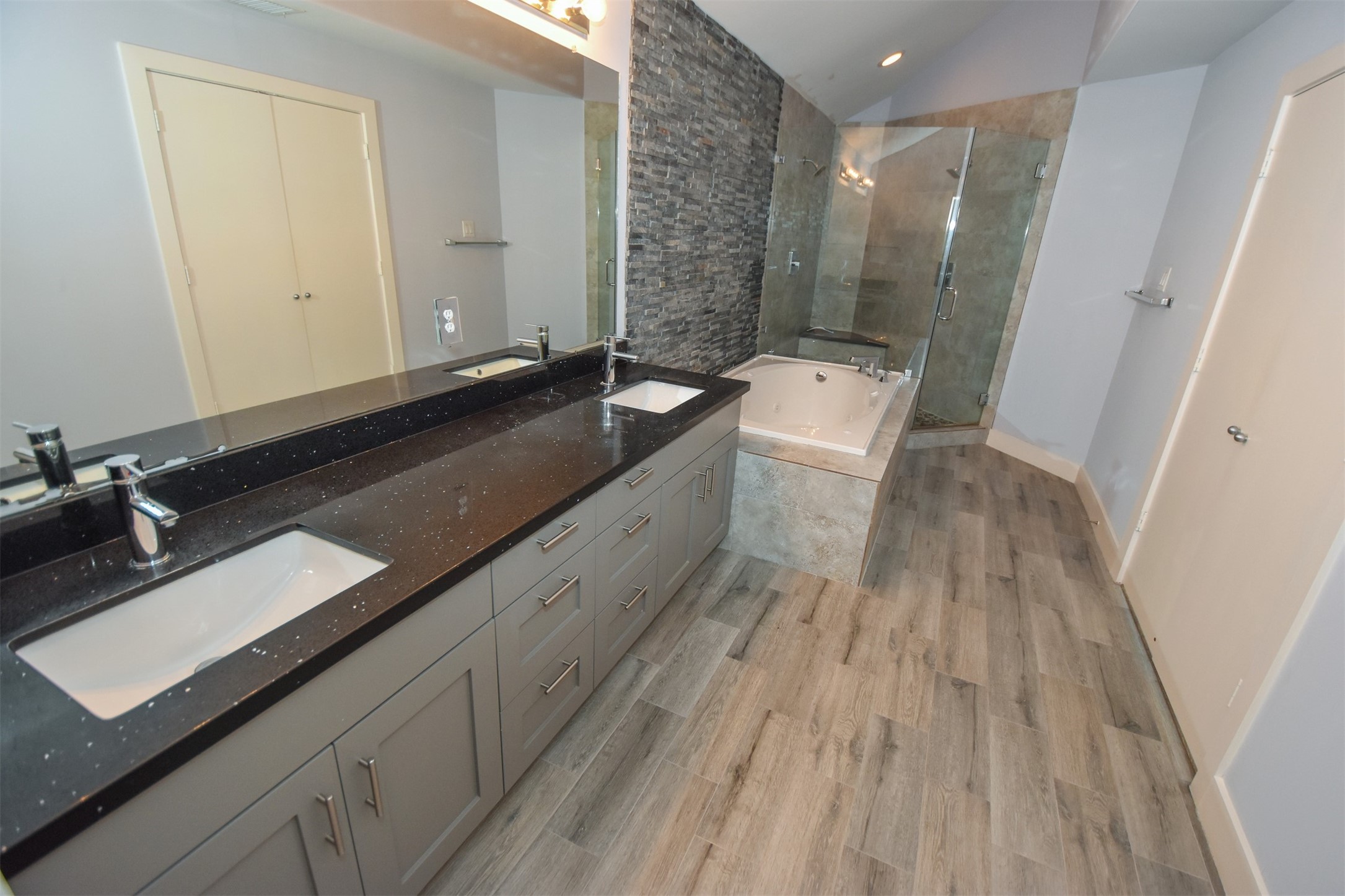 Another view of updated Bathroom with Granite counter & dual sinks. .
