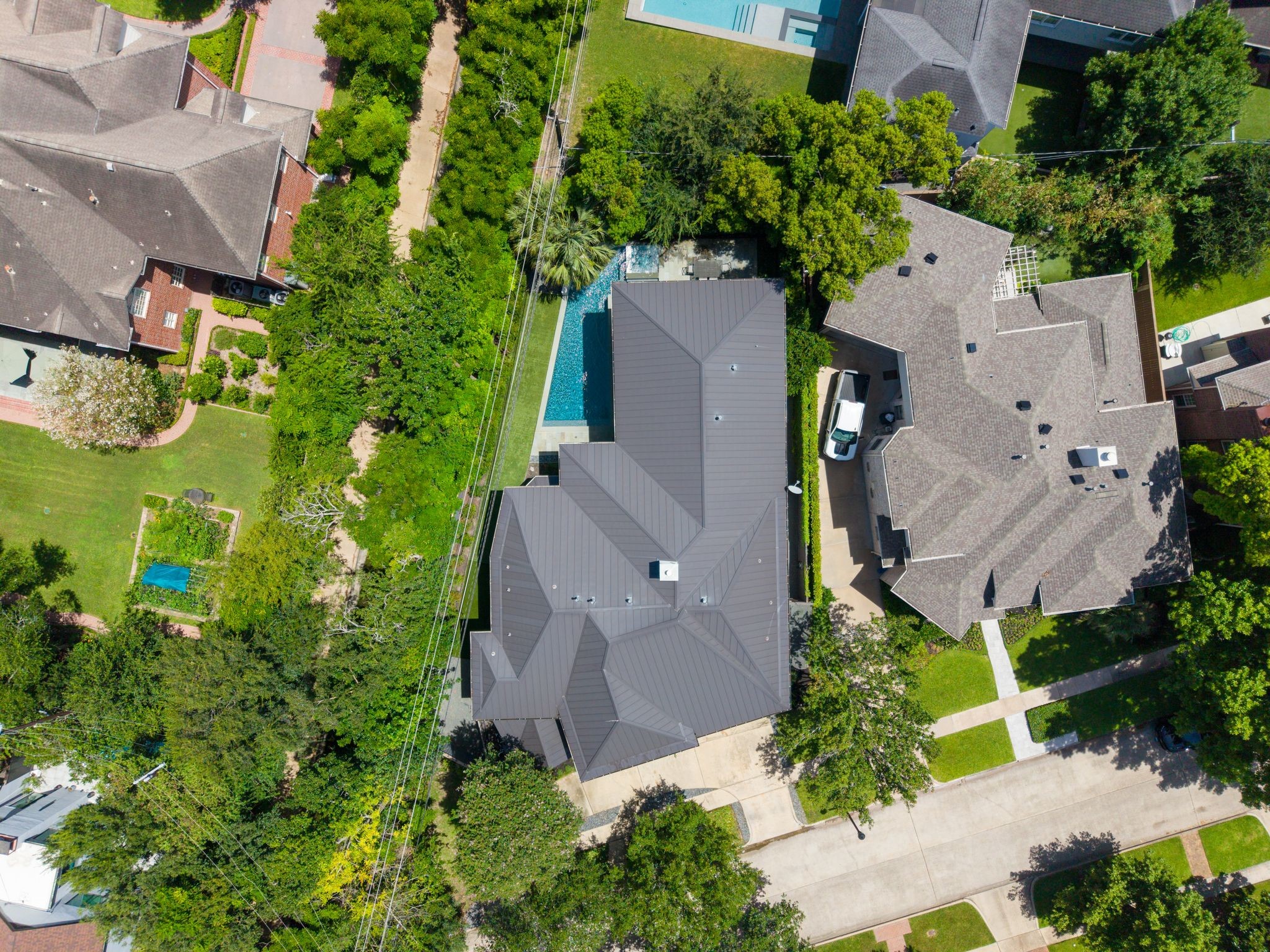 Situated on an exclusive cul-de-sac in the heart of West University, this aerial view captures the home's generous footprint, private pool, mature landscaping, and premier location in the sought-after 3700 block.