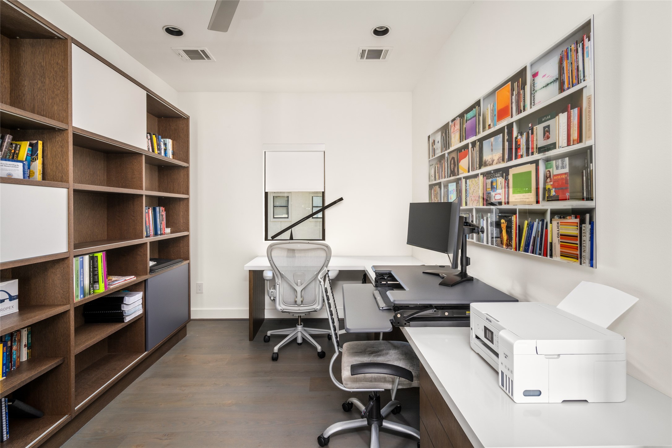 Flexible upstairs office with custom built-ins and generous workspace, ideal for working from home, a creative studio, craft room, or homework center.