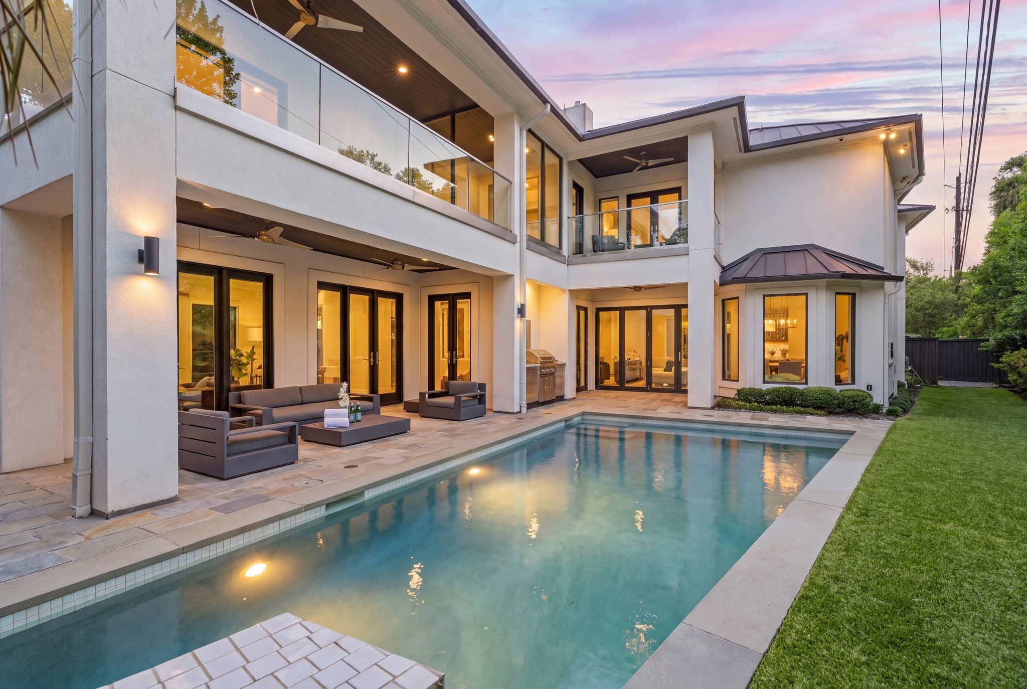 Your private outdoor retreat features a resort-style pool, covered patio, summer kitchen, and multiple balconies overlooking the backyardcreating the perfect setting for year-round entertaining and relaxation.
