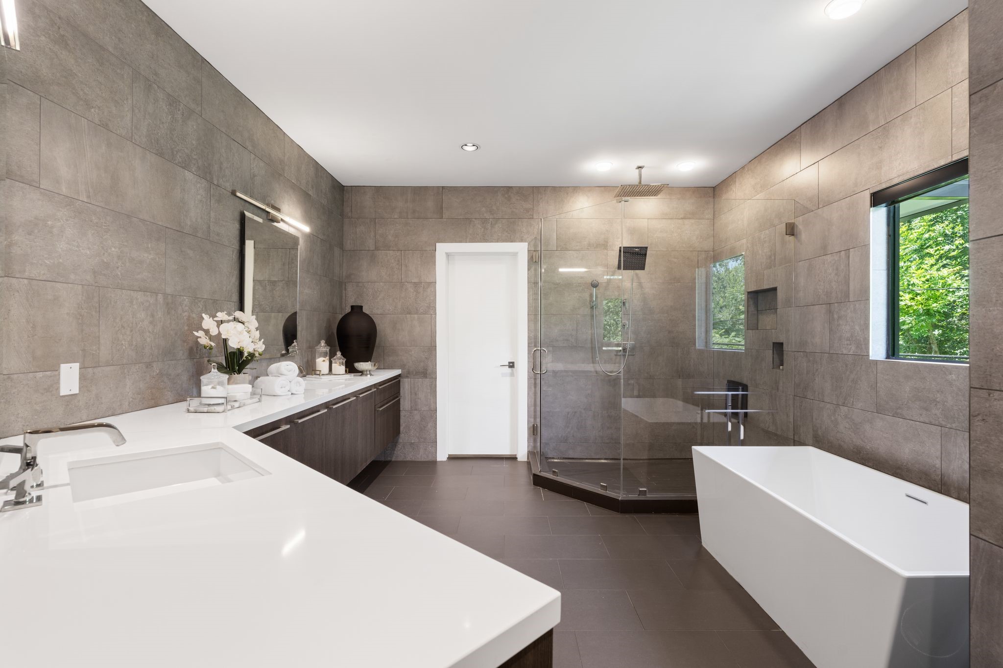The spa-inspired primary bath offers a freestanding soaking tub, oversized walk-in shower with dual rain shower heads, expansive dual vanities, and separate his-and-hers walk-in closets for exceptional comfort and functionality.