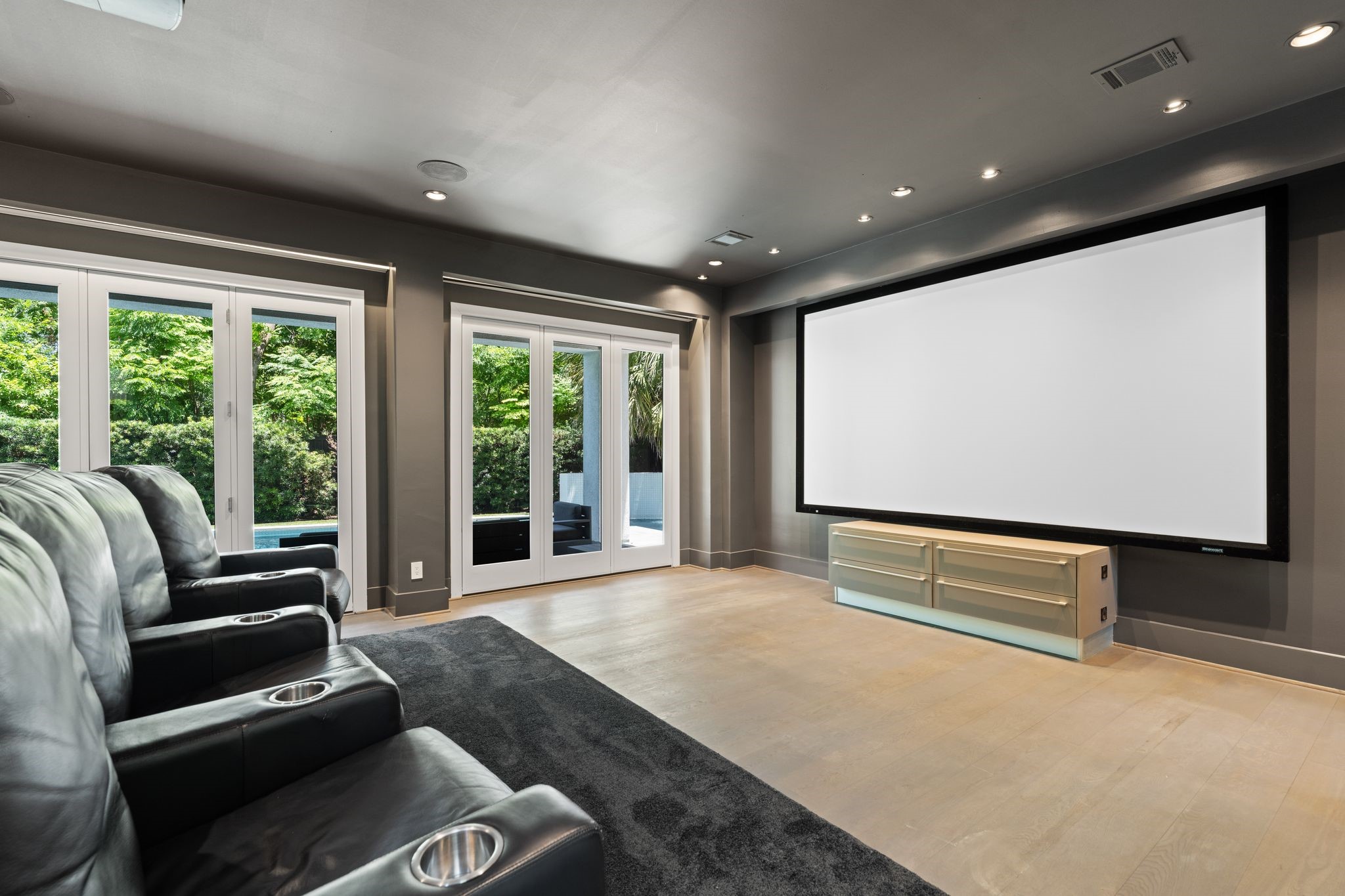 Enjoy a true cinematic experience in the dedicated theater room, complete with a large projection screen, surround sound, and direct access to the poolperfect for movie nights, game days, and entertaining.