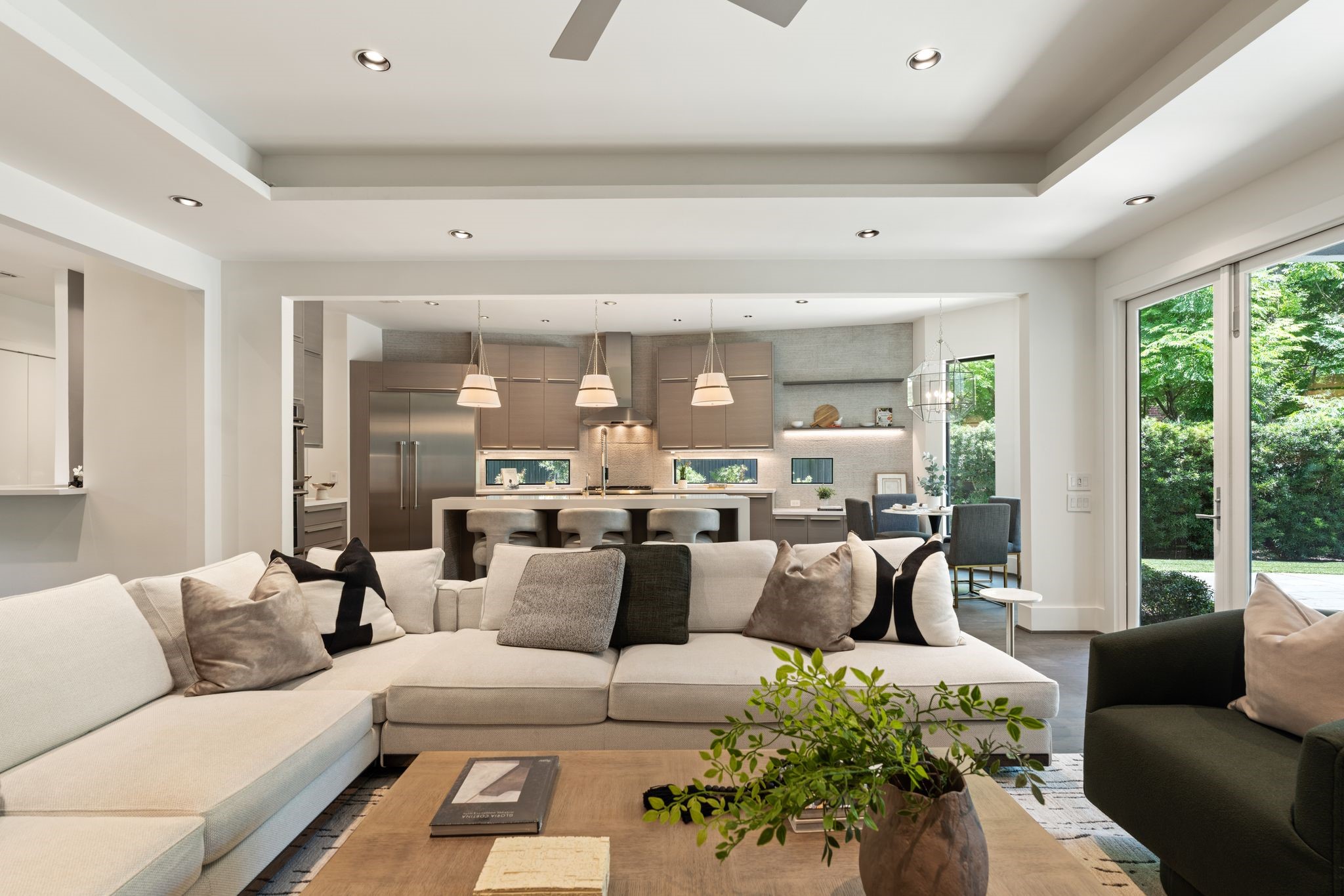 The open-concept family room flows seamlessly into the designer kitchen and breakfast area, creating an inviting space ideal for everyday living and effortless entertaining.