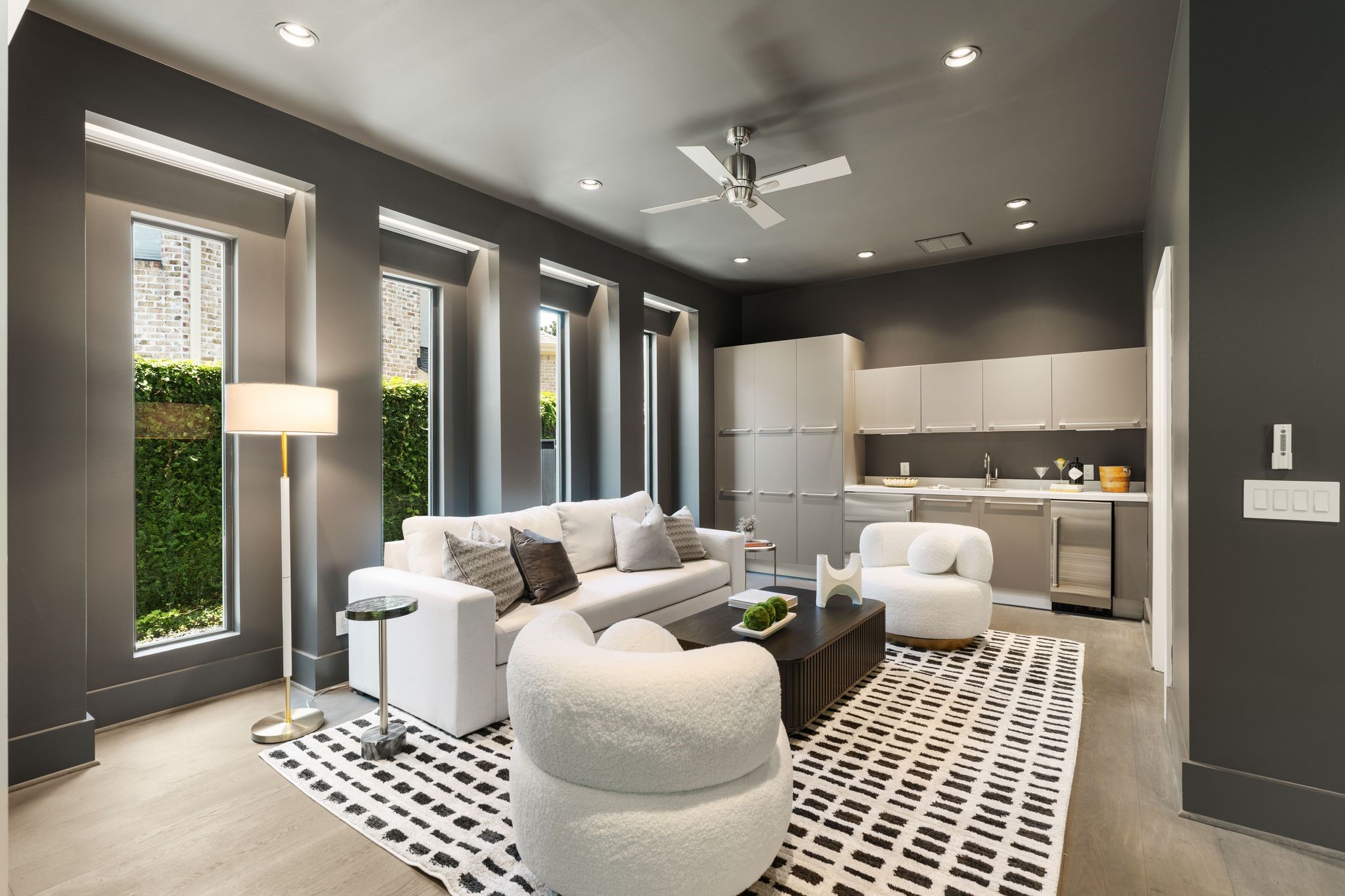 Designed for entertaining, the expansive game room features a stylish wet bar with custom cabinetry, beverage refrigerator, and flexible space for gaming, media, or casual gatherings.
