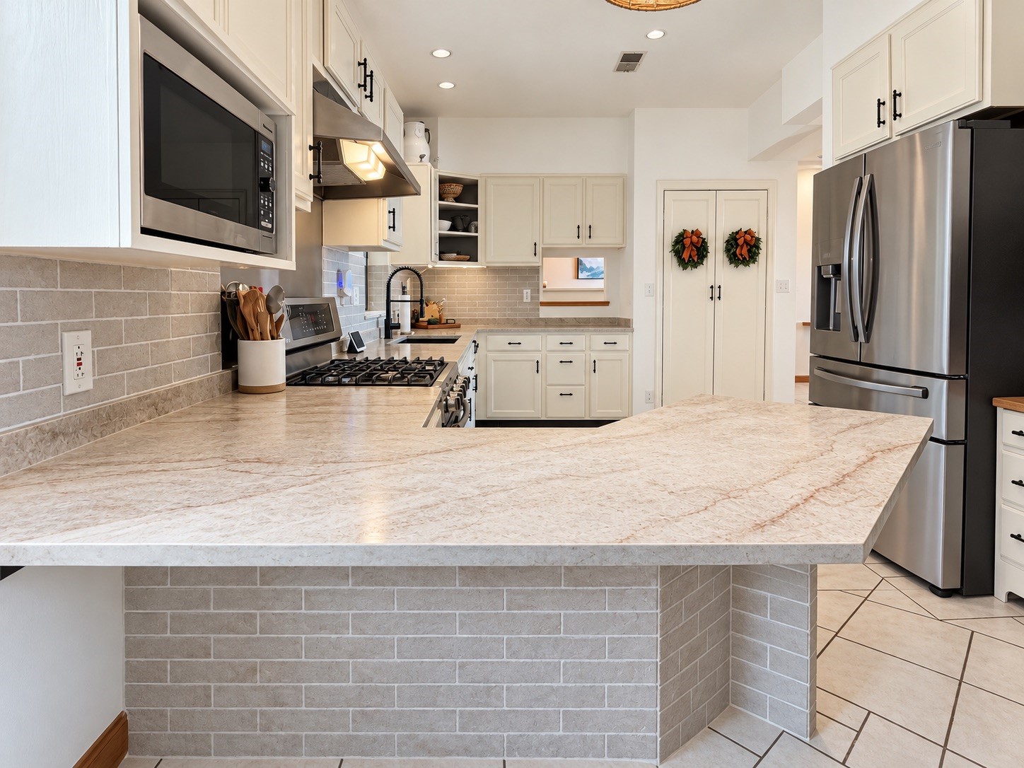 Modern kitchen with sleek stainless steel appliances, ample cabinetry, and a spacious granite countertop, perfect for culinary enthusiasts.