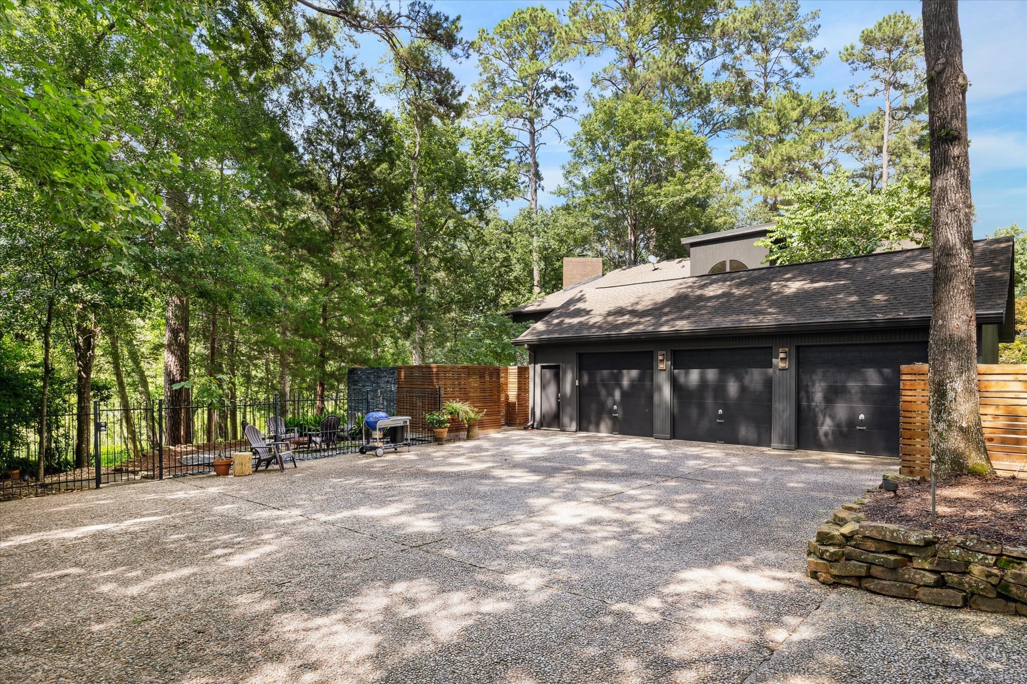 Oversized three-car garage with ample room for vehicles, storage, and workshop or hobby use.