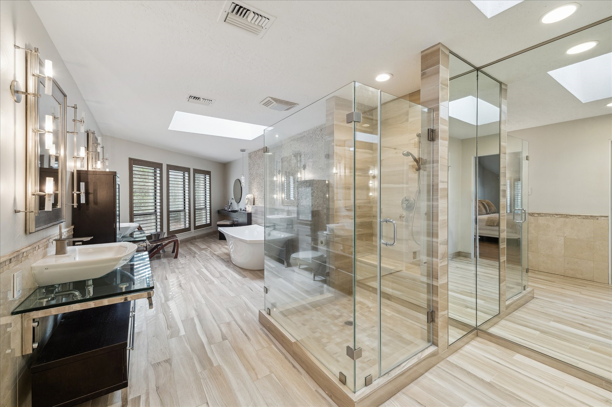 Skylights illuminate its luxurious ensuite, featuring a frameless glass shower and a deep soaking tub where you can unwind beneath the sunlight or stars.