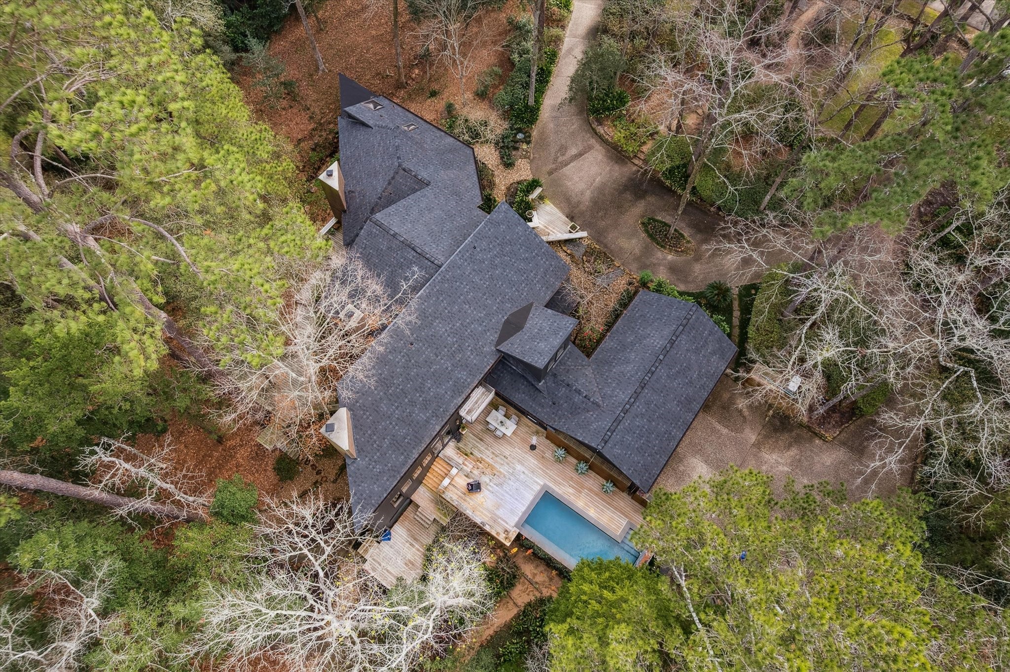 Truly one-of-a-kind architectural gem, tucked beneath a lush canopy of mature trees and offering the peaceful, elevated feel of a private treehouse retreat, quietly nestled within the prestigious Holly Creek Estates community.