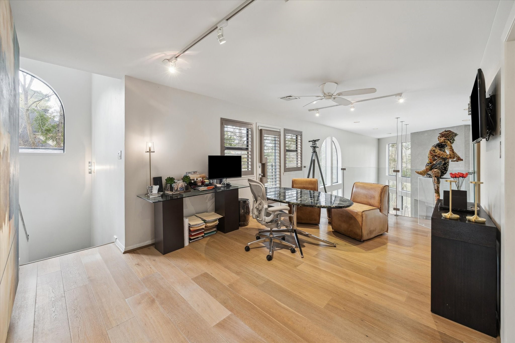 Versatile loft space with views of the main living areas, perfect for a home office, media room, or quiet retreat, seamlessly blending openness and privacy. This area can easily be converted back into a fourth bedroom.