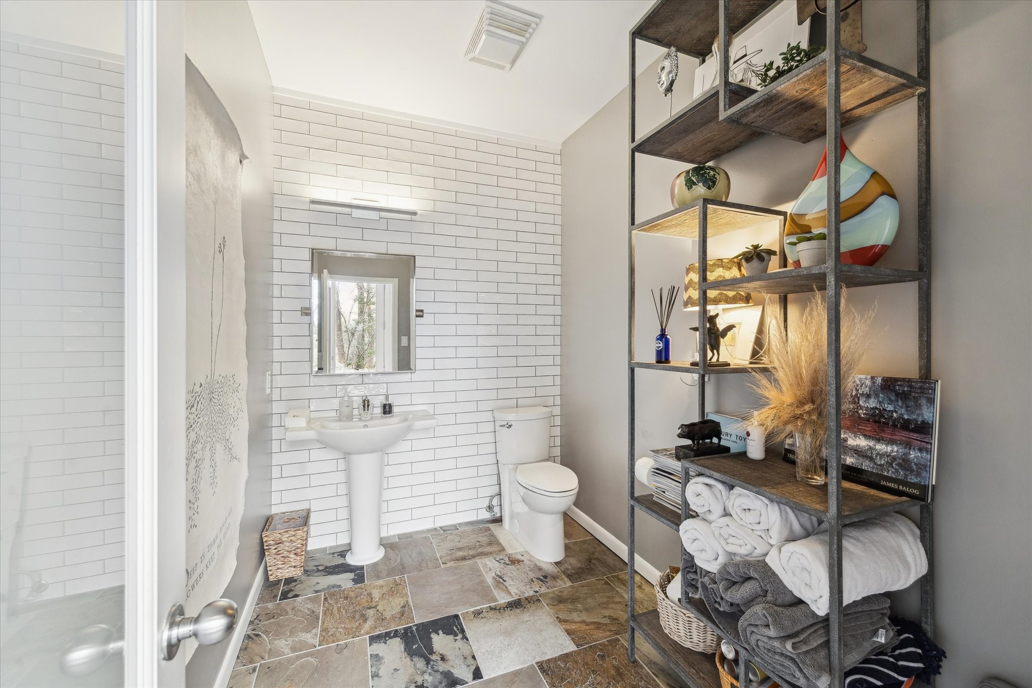 Tastefully finished poolside half bath, perfectly positioned to serve outdoor living and entertaining spaces.