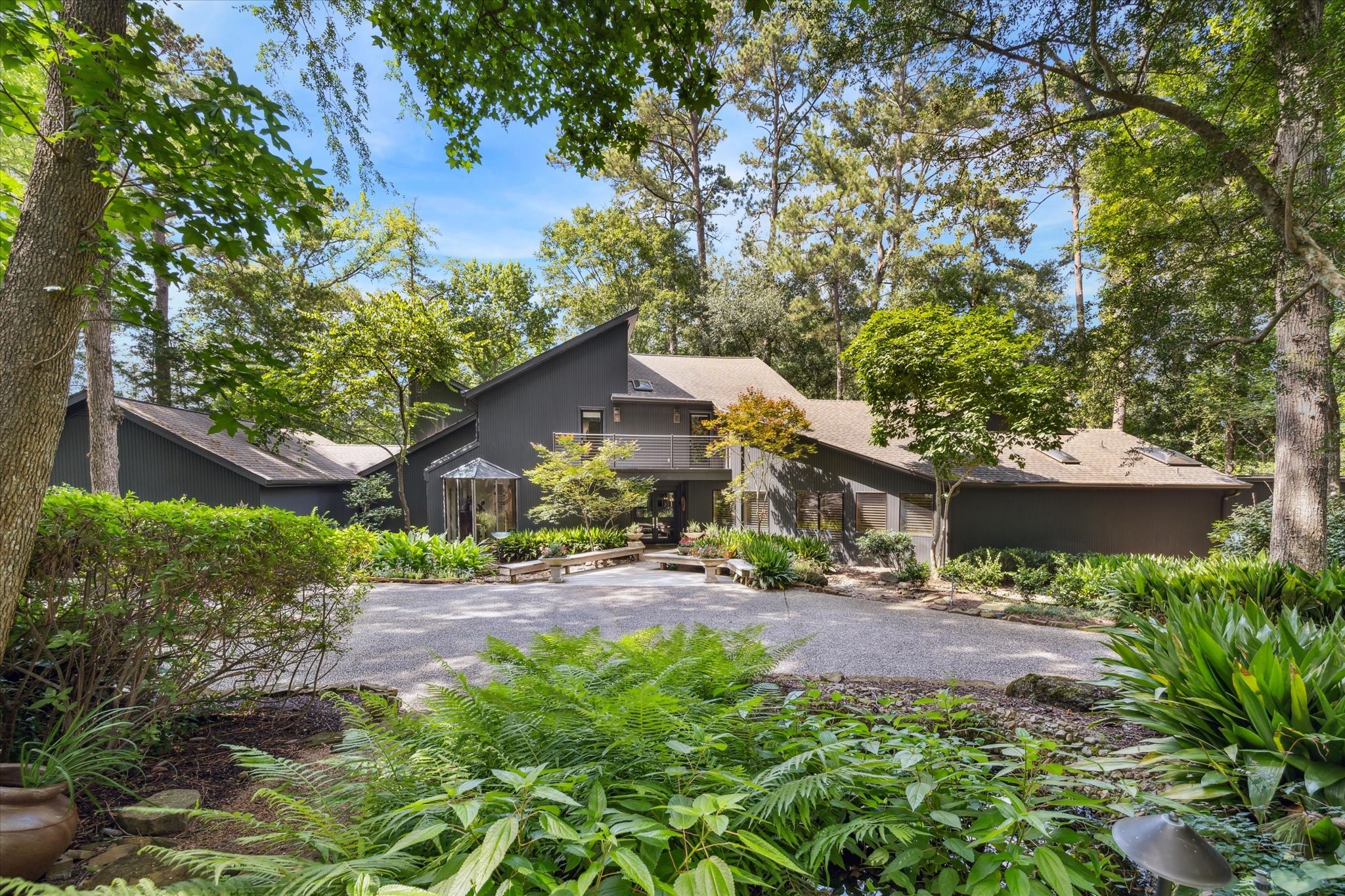 Nestled among mature trees, this striking contemporary home offers a private, park-like setting with exceptional curb appeal. Nestled among mature trees, this striking contemporary home offers a private, park-like setting with exceptional curb appeal.