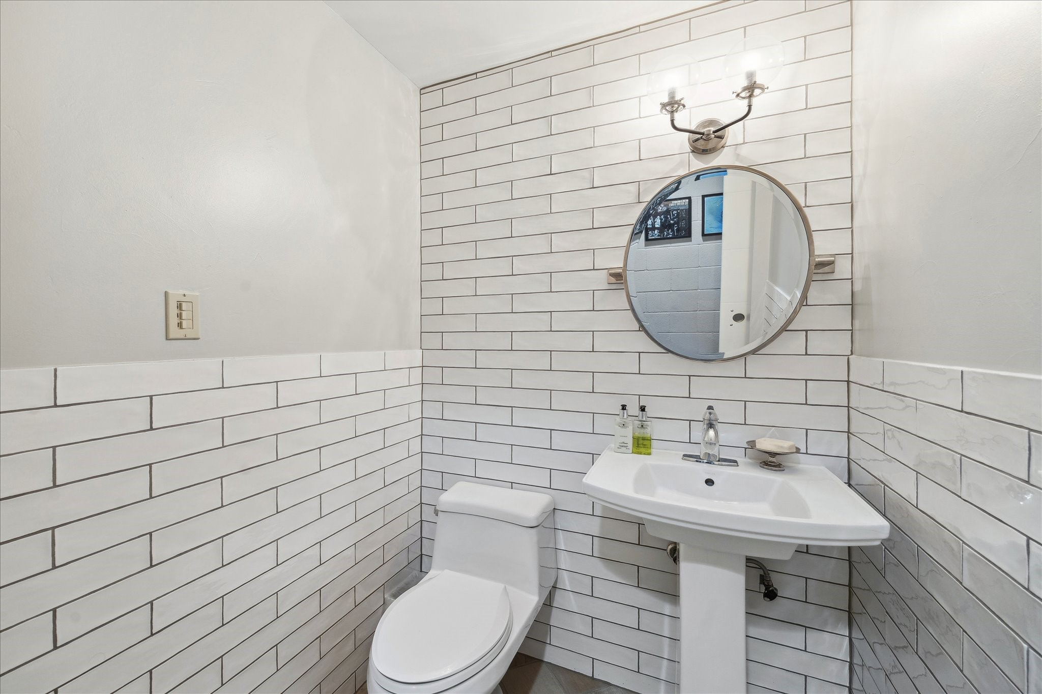 Half bath tucked into the lower level, offering a convenient and polished space for guests or family use.