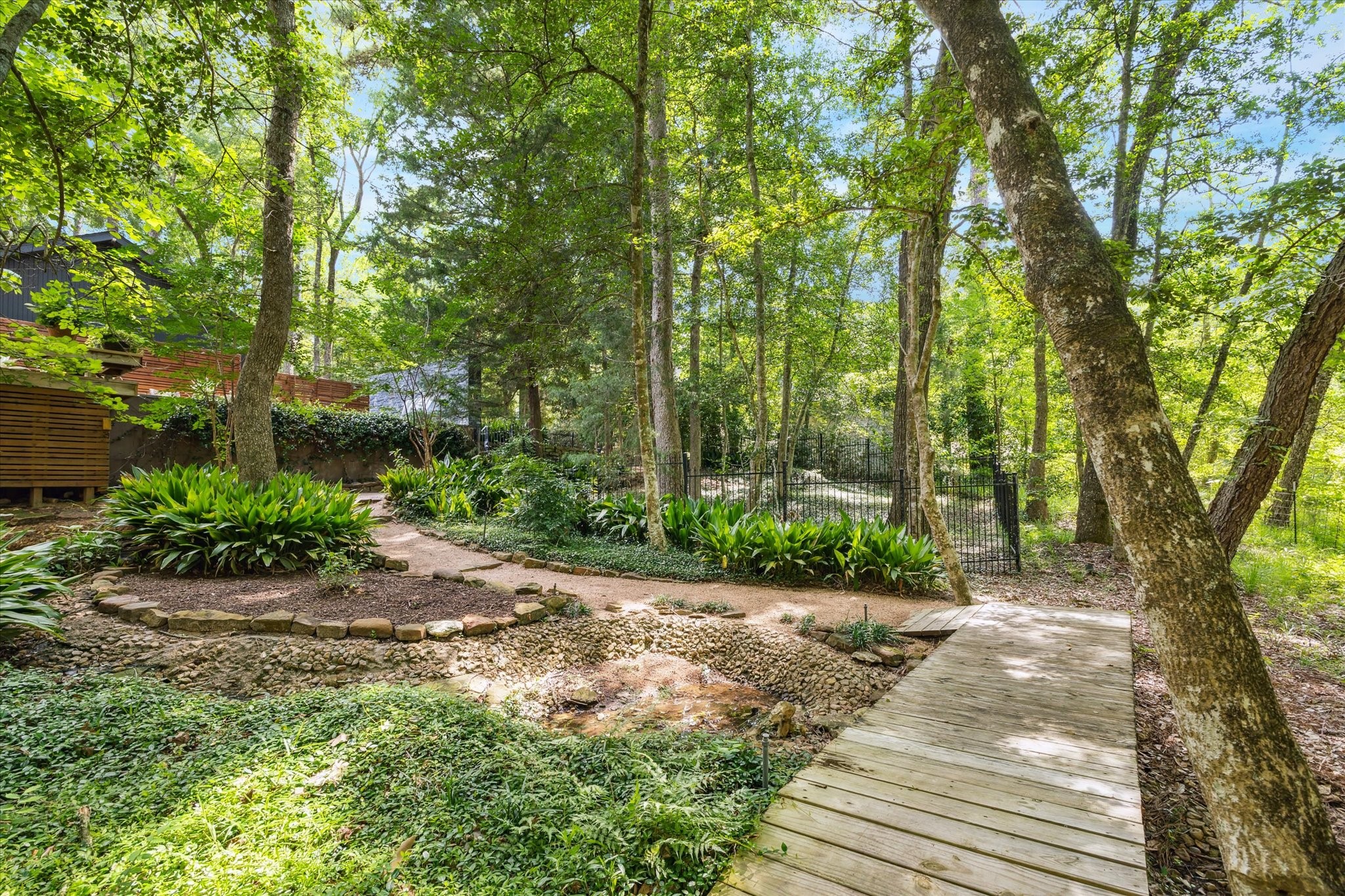 Surrounded by mature trees and greenery, reinforcing the homes retreat-like setting.