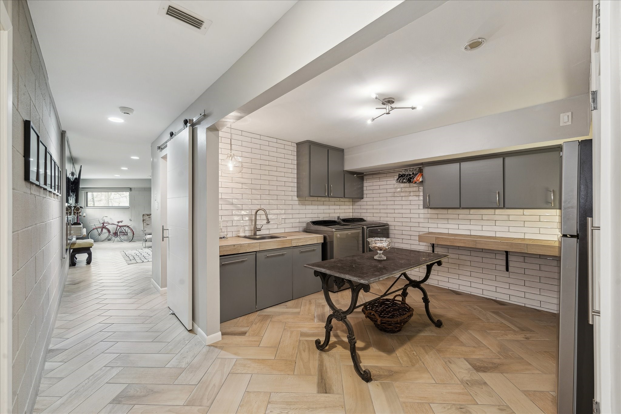 The large utility room adds practical function with its sink, counter space and abundant storage. There is space for a full-size refrigerator.