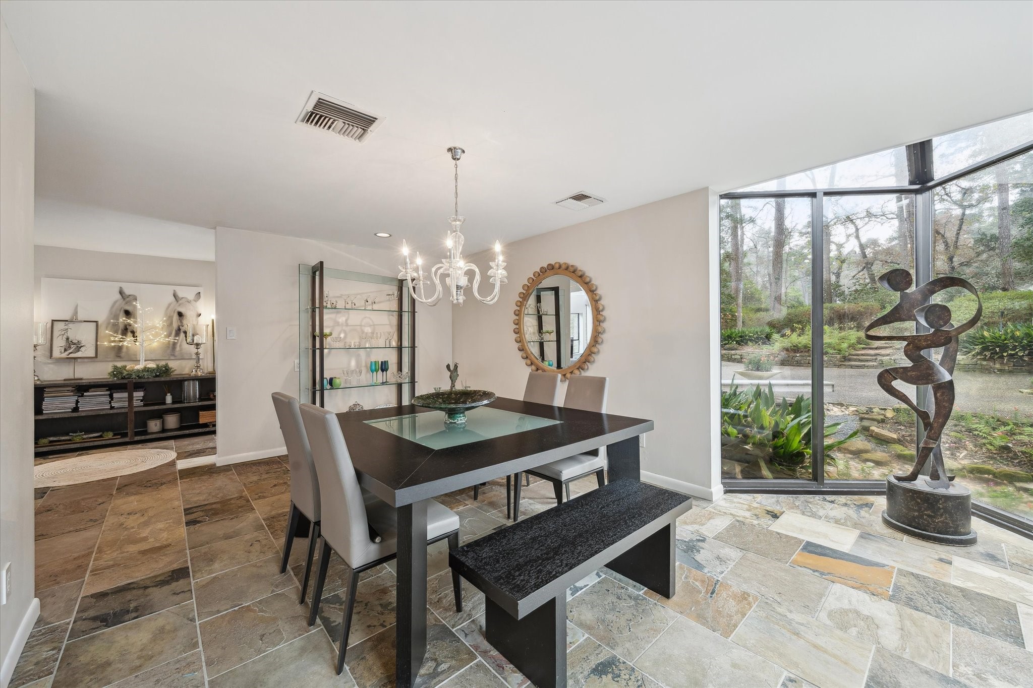 Elegant dining space illuminated by natural light, offering serene views and a seamless connection to the outdoors.