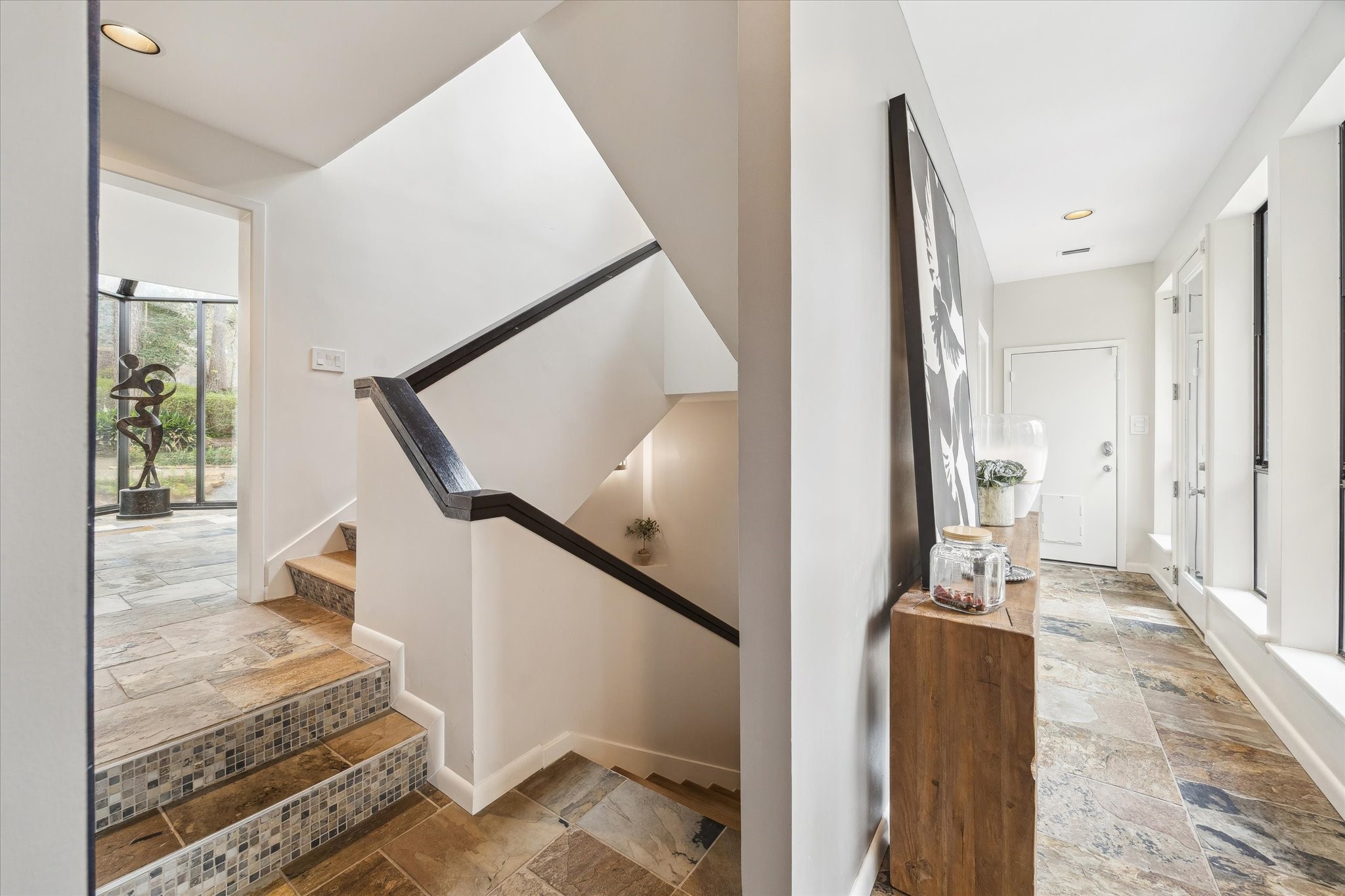 Stairs designed as a visual experience, surrounded by light and natural textures.