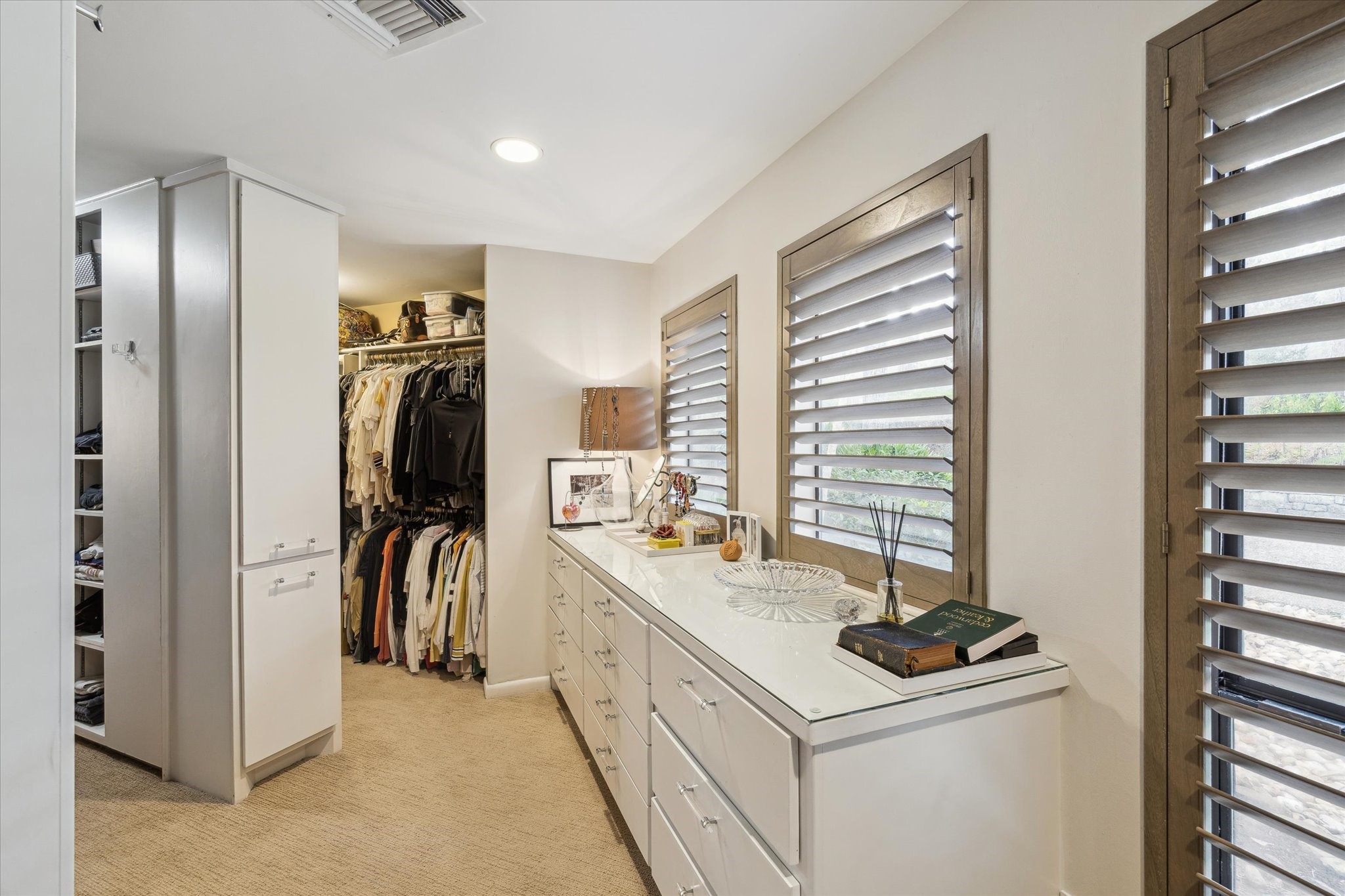 Abundant storage throughout, including custom and walk-in closets, maximizing organization and functionality.