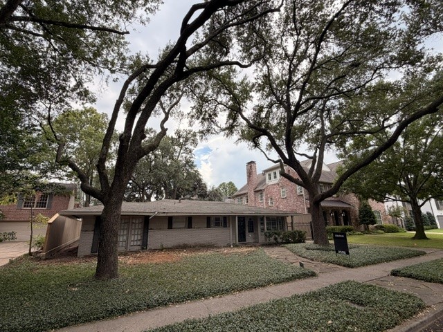 A view of the existing home showcasing the beautiful existing Live Oaks. A view of the existing home showcasing the beautiful existing Live Oaks.