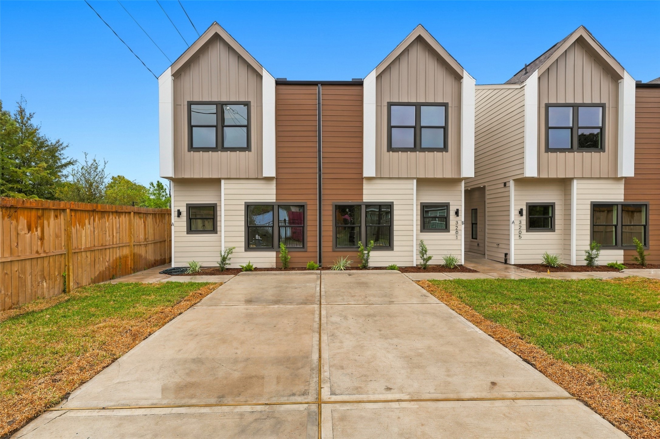 Modern duplexes featuring a stylish exterior with clean lines, gated driveway, and a lush green lawn, offering both security and curb appeal. Modern duplexes featuring a stylish exterior with clean lines, gated driveway, and a lush green lawn, offering both security and curb appeal.